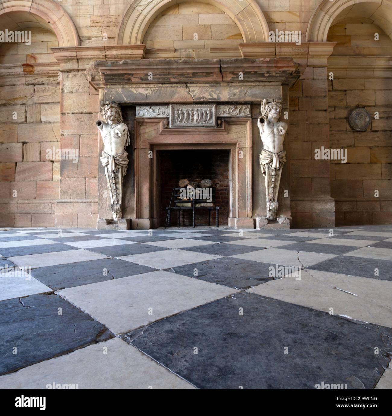 Statues either side of a fireplace at Deleval Hall Stock Photo Alamy