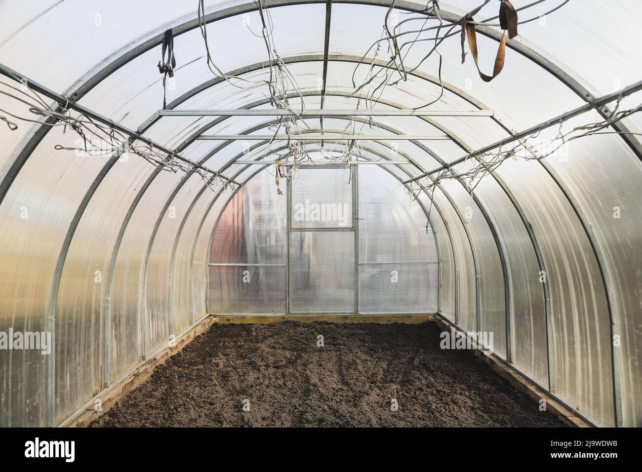 The empty greenhouse before planting. Plowed earth Stock Photo