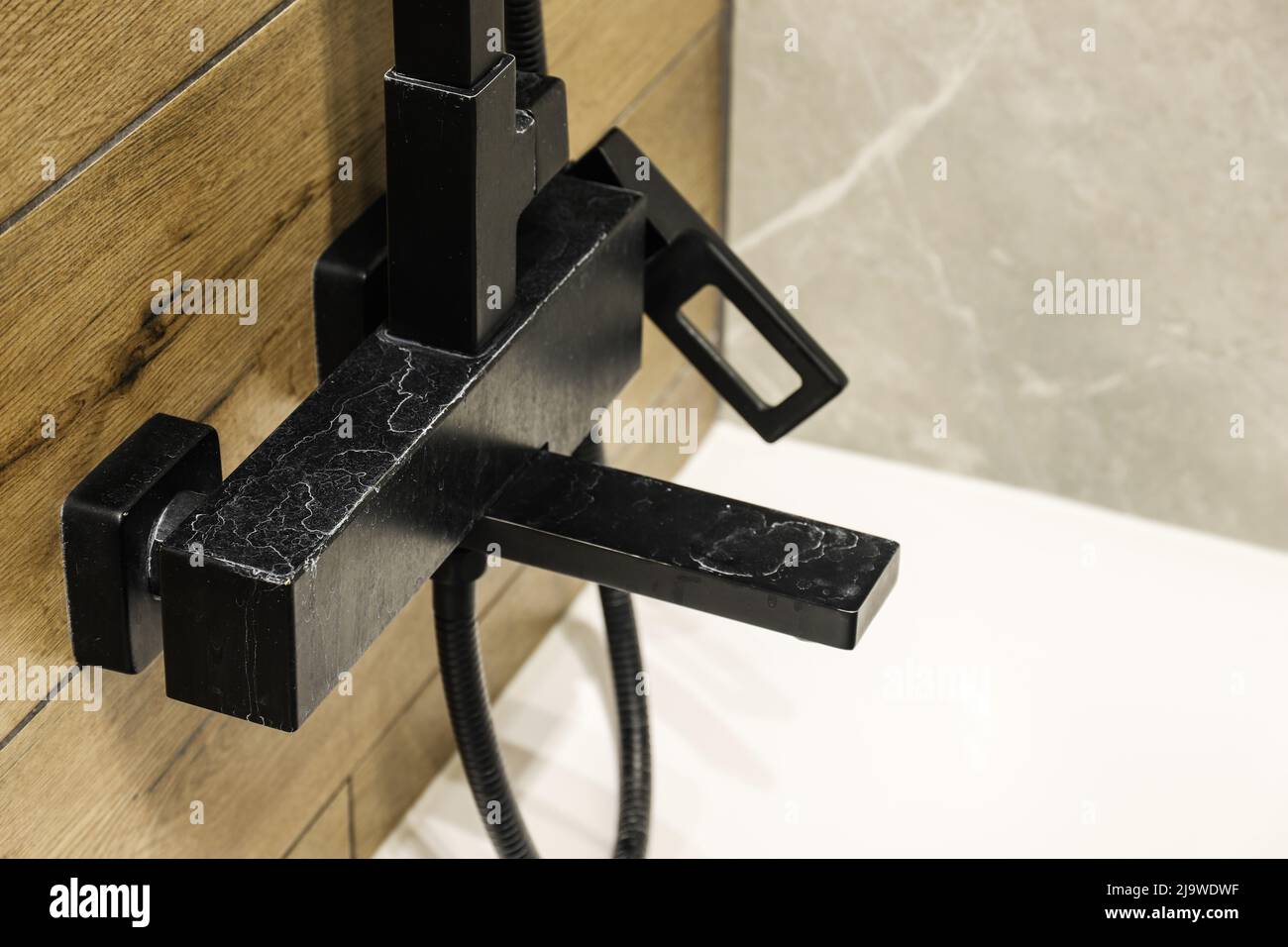 Black faucet with limescale deposits due to water hardness close-up Stock Photo