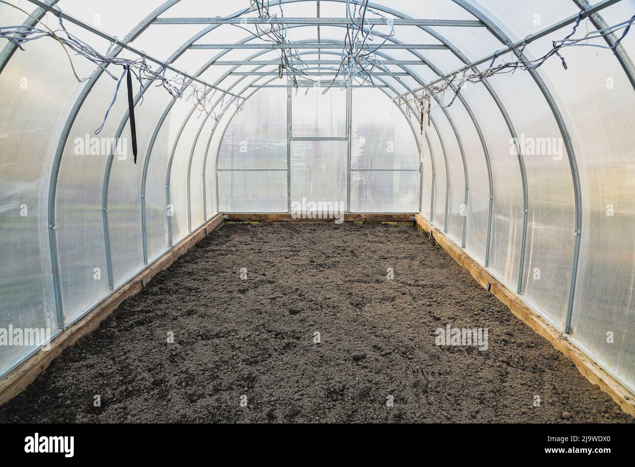 The empty greenhouse before planting. Plowed earth Stock Photo