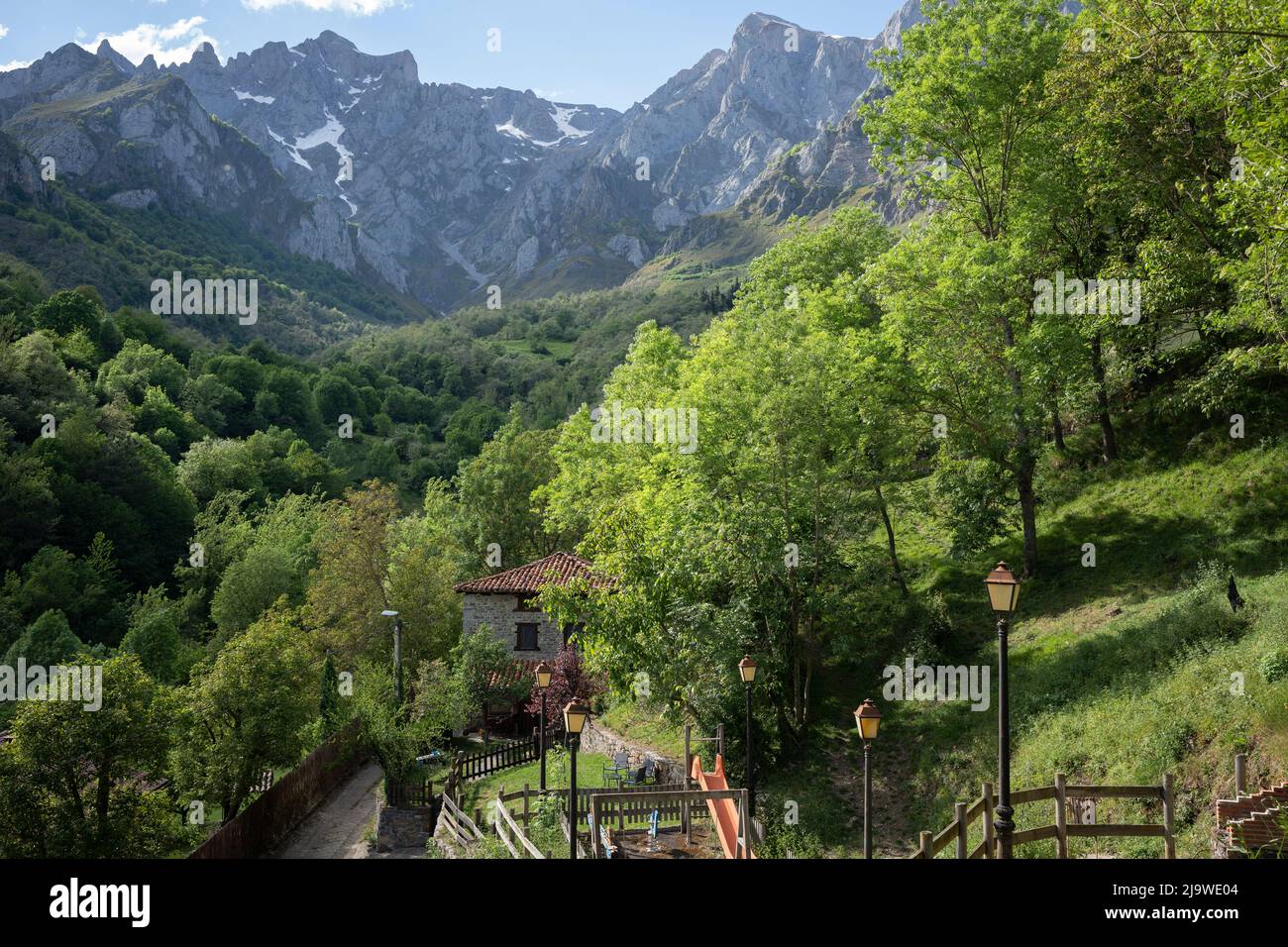 A landscape of foothills and mountain peaks above the hamlet of Lon near Potes, a popular tourist gateway for those entering the Spanish Picos de Europa National Park region, on 17th May 2022, Lon, Asturias, Spain. Stock Photo