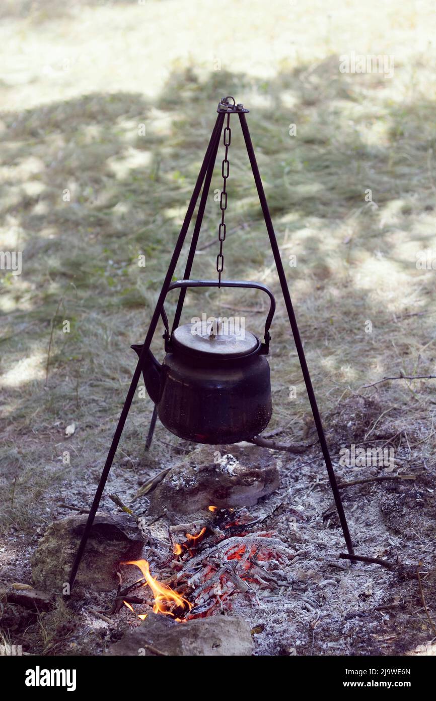 Camp fire and the black kettle of coffee