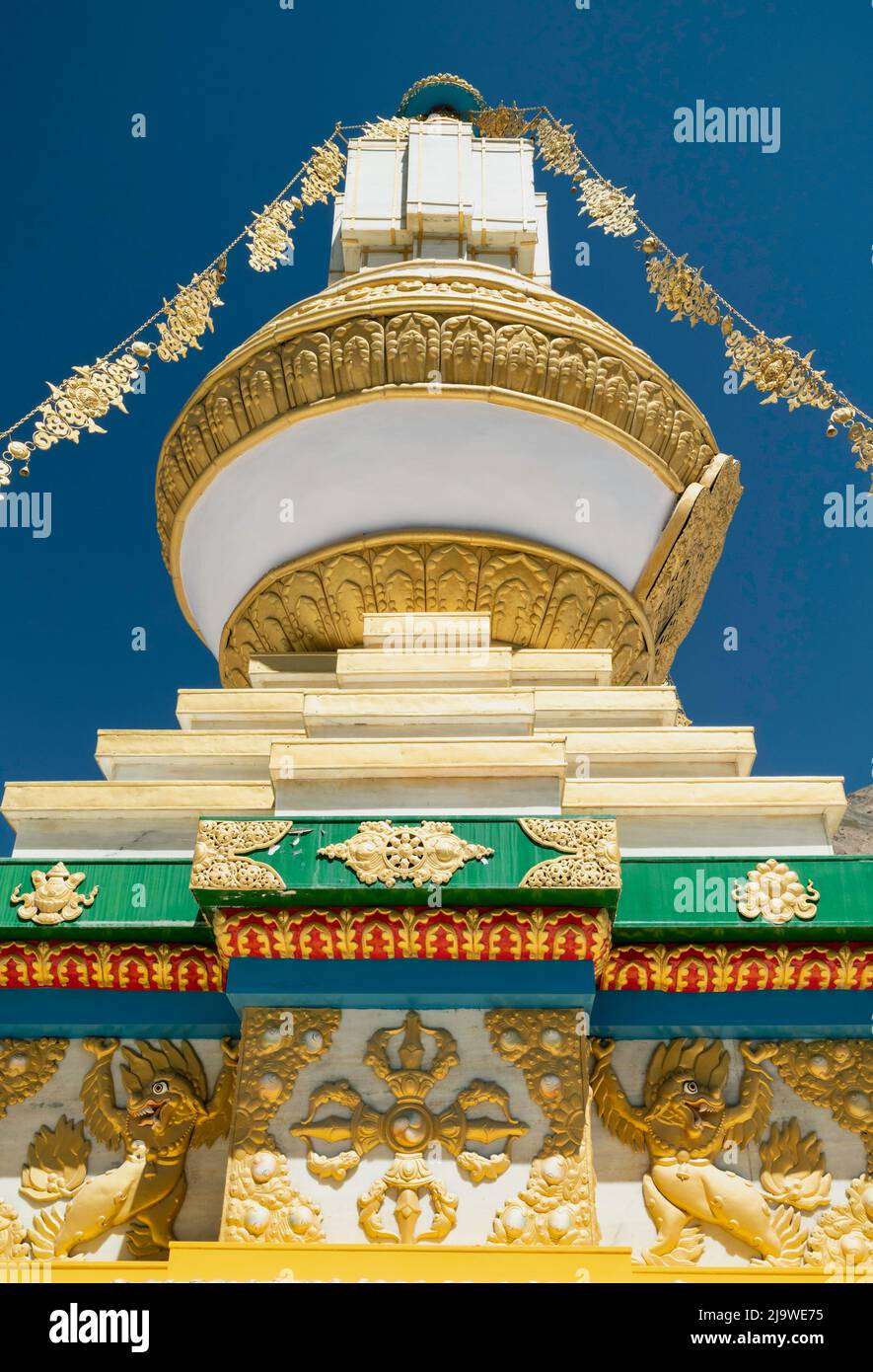 Buddhist stupa decorated in beautiful colours situated inside the gounds of the ancient monastery under blue sky in Tabo, Himachal Pradesh, India. Stock Photo