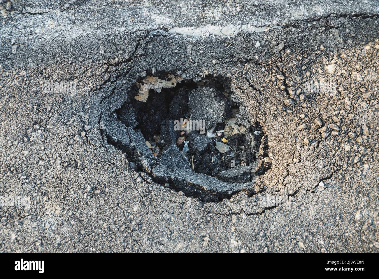 Asphalt swelling close-up. Pothole and pit on road Stock Photo - Alamy