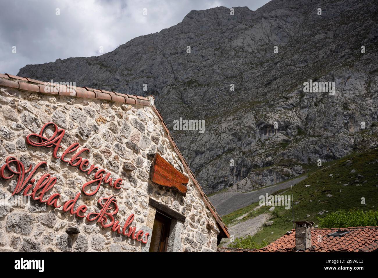 An Alberge shelter in Bulnes, a popular Spanish hiking destination for visitors to the Picos de Europa National Park, on 15th May 2022, at Bulnes, Picos Mountains, Asturias, Spain. Reached by path or by funicular railway, the tiny village of Bulnes provides overnight beds and food to passing walkers. Stock Photo