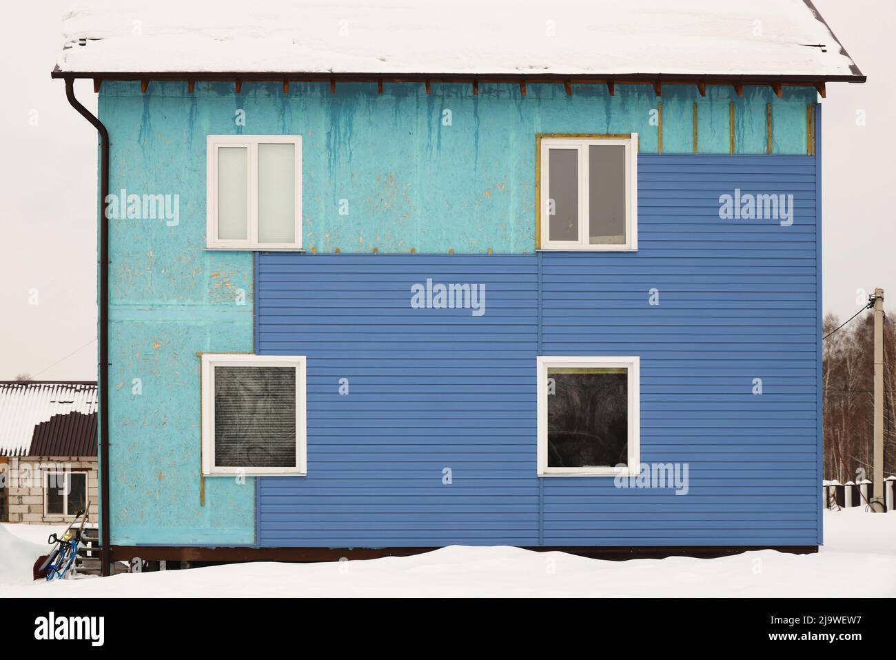 Wall covering of the old house with panels of vinyl siding
