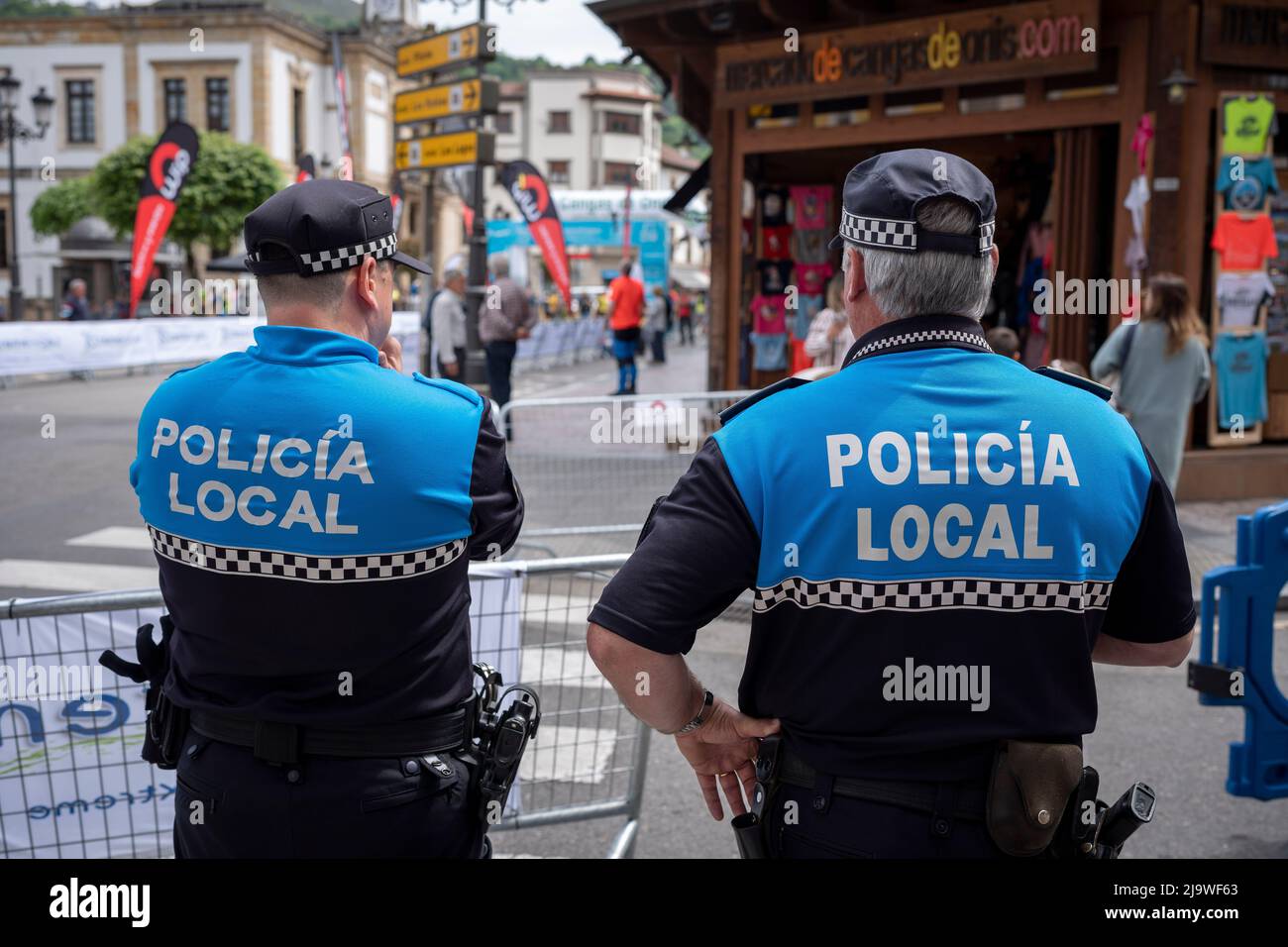 Two local police officers (Policia) provide security during a Spanish trail running event, on 14th May 2022, in Congas de Onis, Picos Mountains, Asturias, Spain. Stock Photo