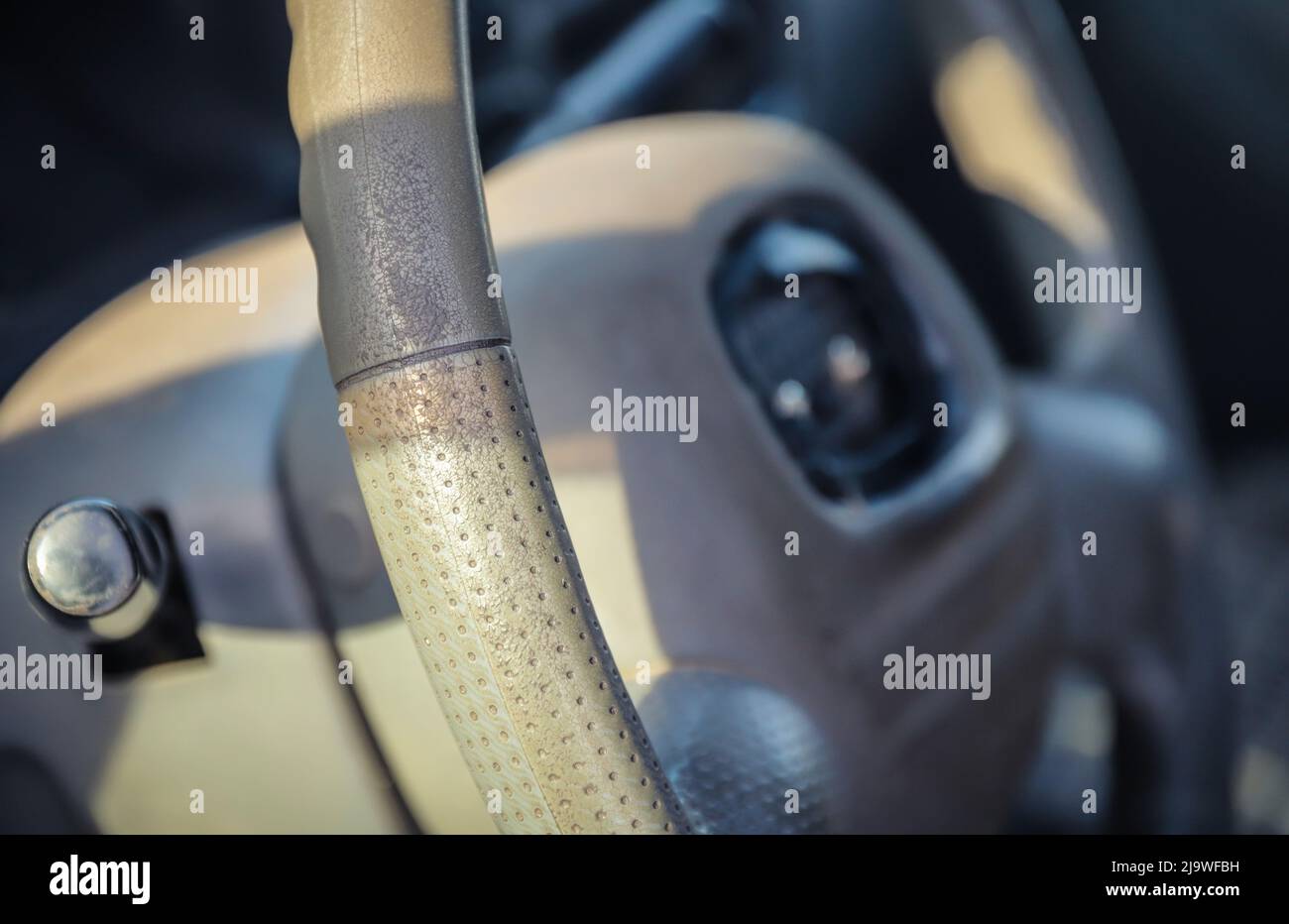 Threadbare automotive gray steering wheel of old auto close-up. Selective focus Stock Photo