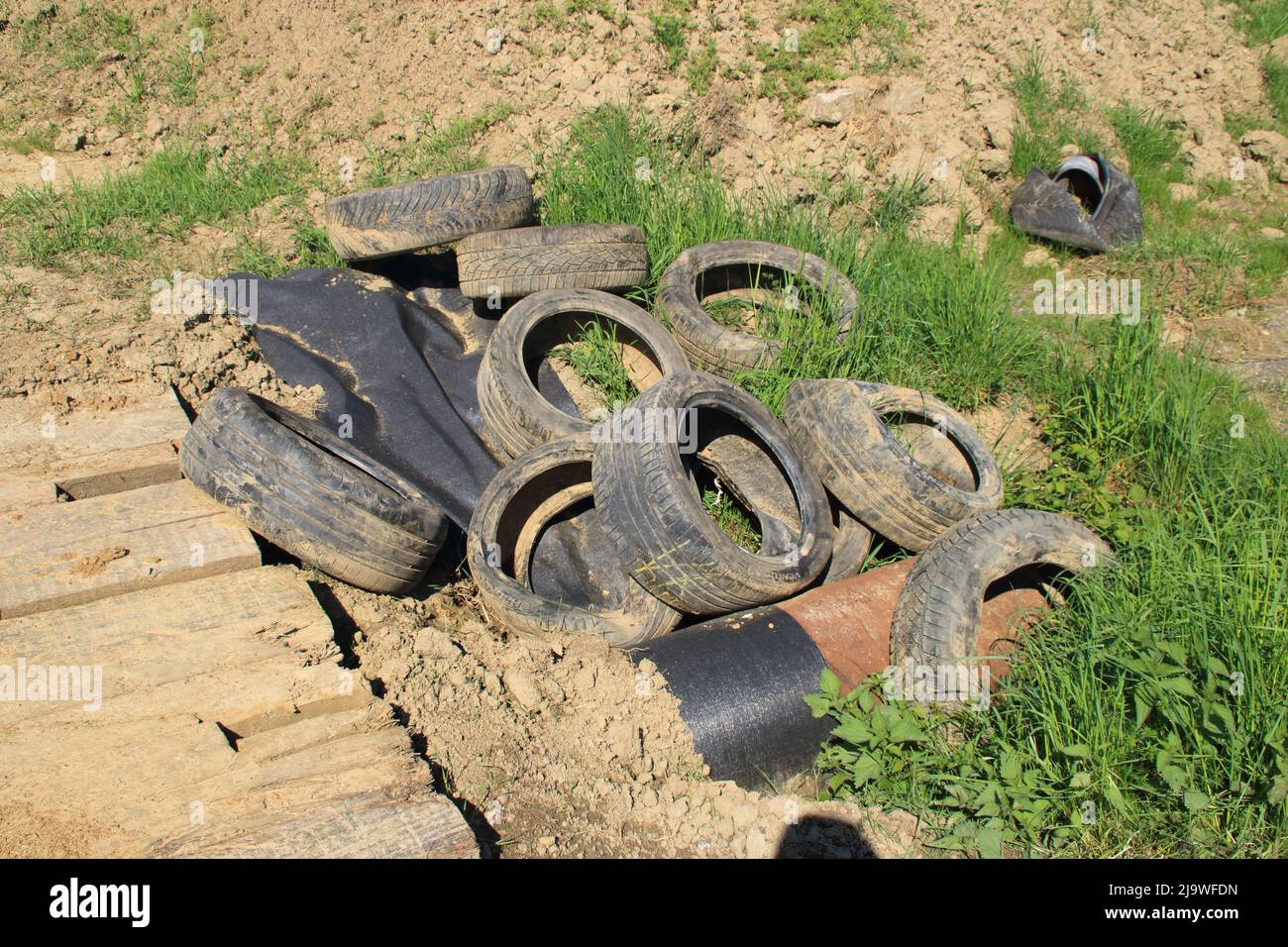 Old tires were dumped on a dirt road Stock Photo