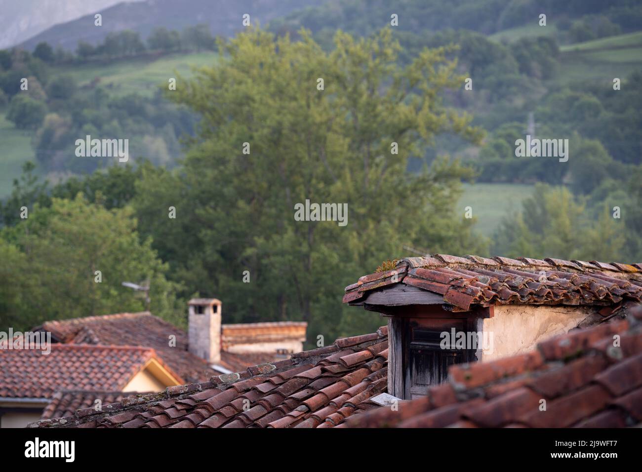 A dormer window and surrounding hills in the Picos mountains massif, on 15th May 2022, in Mesta de Con, Picos Mountains, Asturias, Spain. Stock Photo