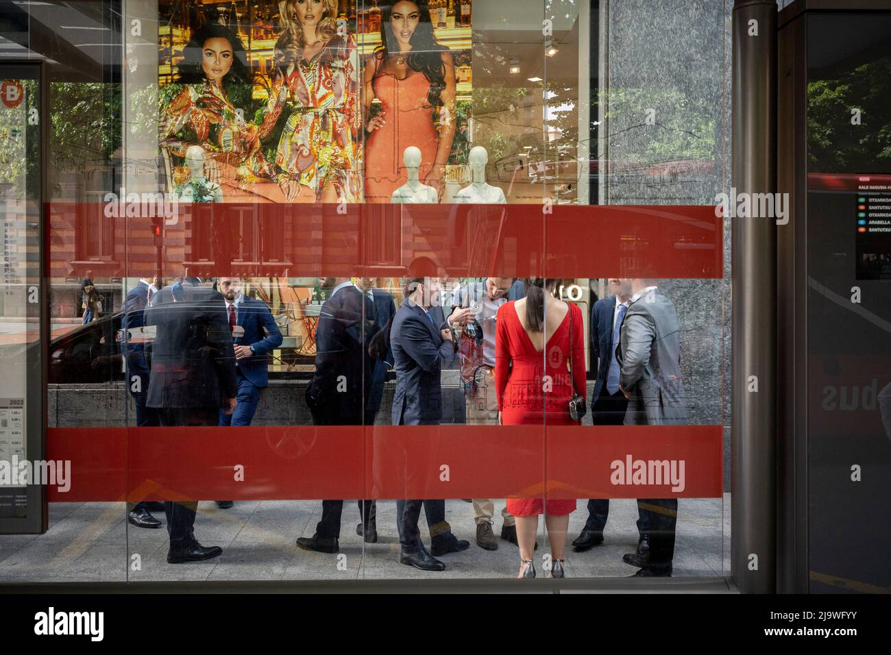 Guests of a Spanish wedding gather outside a clothing retailer on 'Gran via Don Diego Lopez de Haro' in central Bilbao, on 21st May 2022, in Bilbao, Cantabria, Spain. Stock Photo