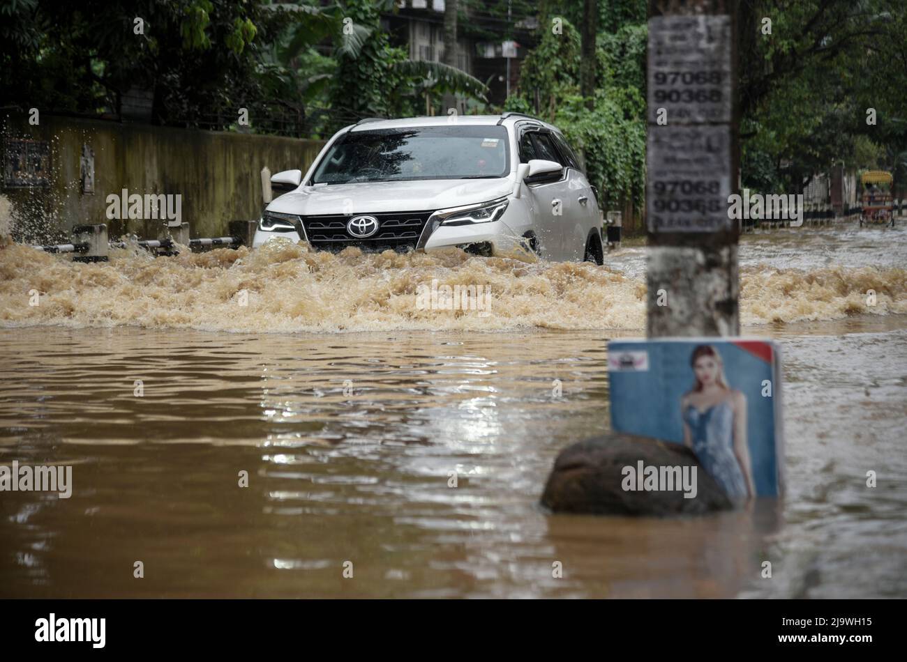 Guwahati, Assam, India. 25th May, 2022. A car wades across a flooded street after heavy rains, in Guwahati, Assam, India on 25 May 2022. Waterlogging is a common scene in Guwahati city due to poor drainage system. Credit: David Talukdar/Alamy Live News Stock Photo