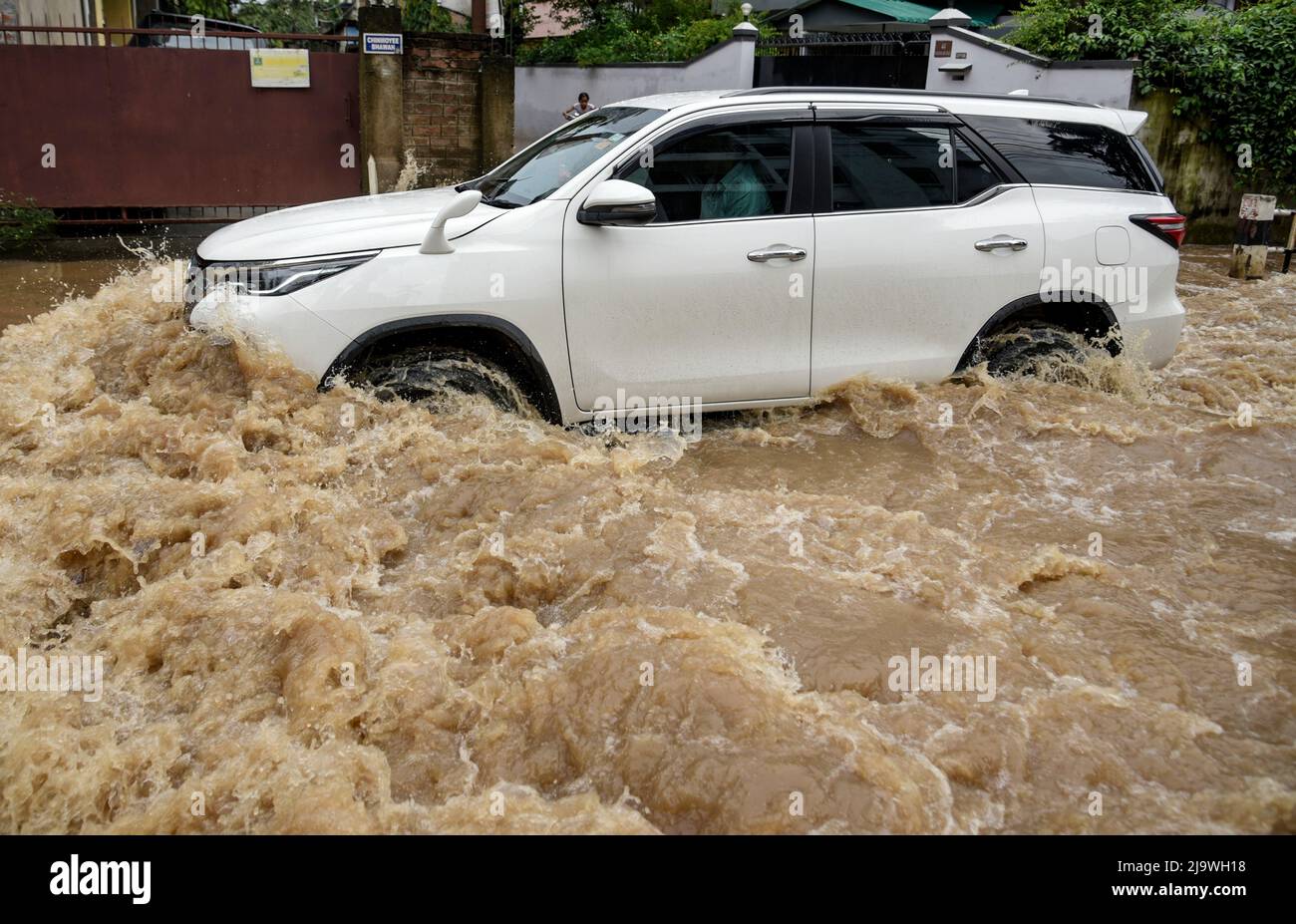 Guwahati, Assam, India. 25th May, 2022. A car wades across a flooded street after heavy rains, in Guwahati, Assam, India on 25 May 2022. Waterlogging is a common scene in Guwahati city due to poor drainage system. Credit: David Talukdar/Alamy Live News Stock Photo