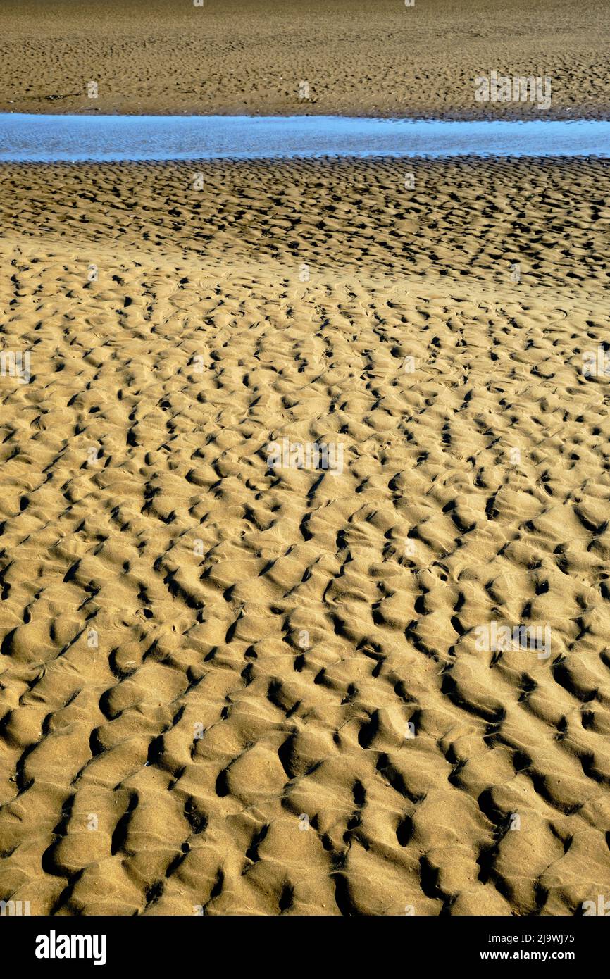 Pattern in the sand of beach texture and ripples Blue and Yellow colours sky and Beach Minimalist Landscape Stock Photo