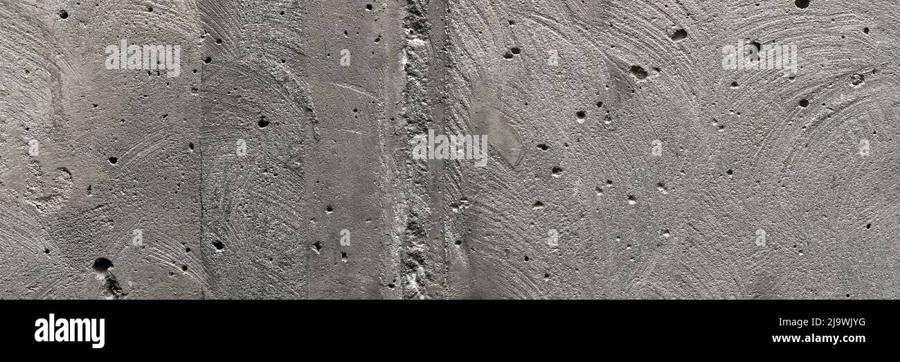 Gray, rough, concrete background texture banner. Stone wall with holes