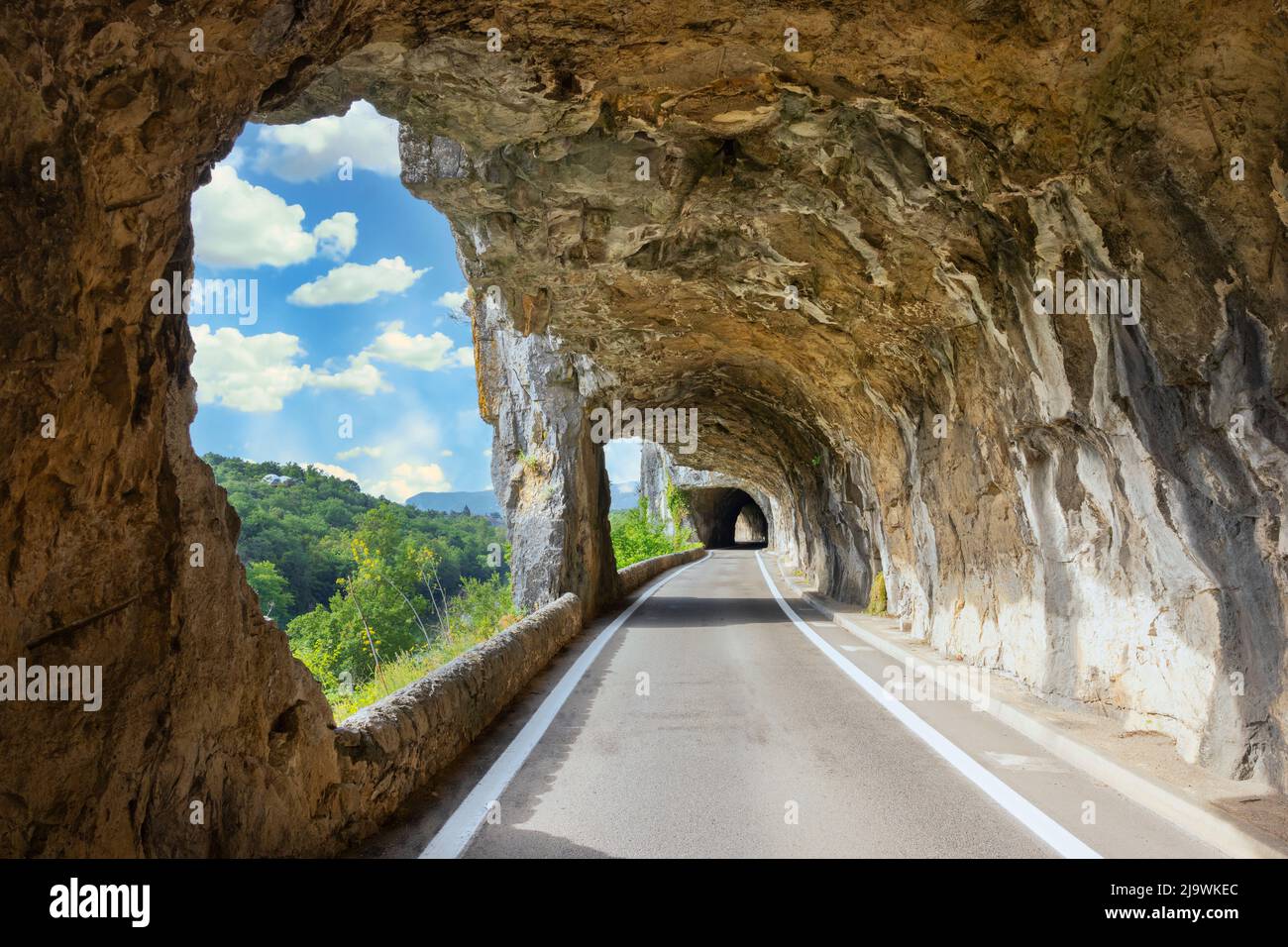 Famous road with arch in the rock called 'defile de Ruoms' at Ruoms, France, Europe Stock Photo