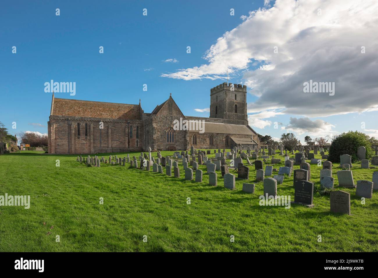 St Aidan's Church Bamburgh, view of the 12th century church and scenic churchyard in the Northumberland coastal village of Bamburgh, England, UK Stock Photo