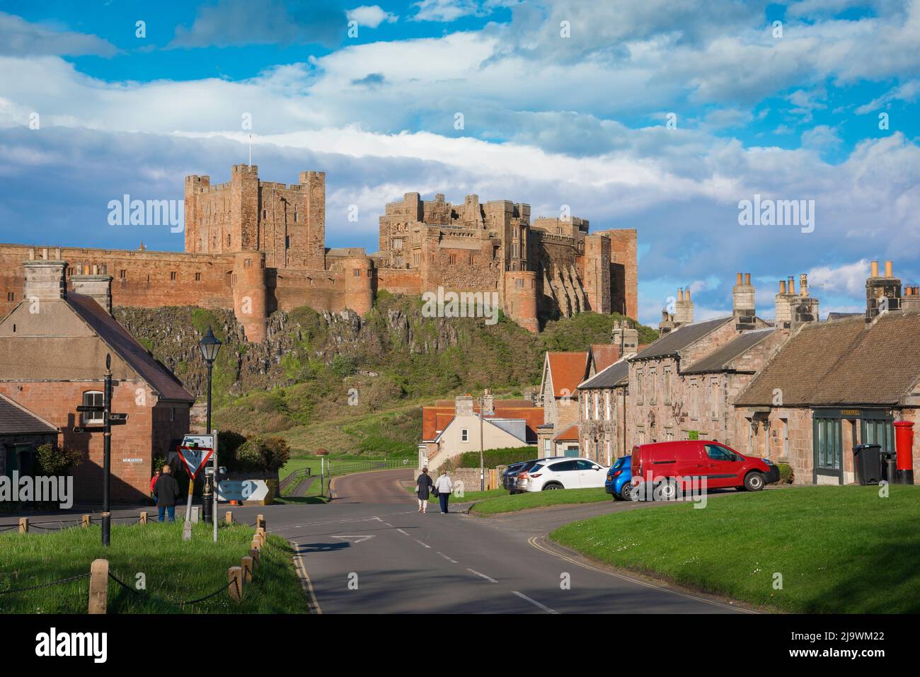 Northumberland castle, view in summer of Bamburgh Castle (dating from 12th Century) sited above Bamburgh village on the Northumberland coast, UK Stock Photo