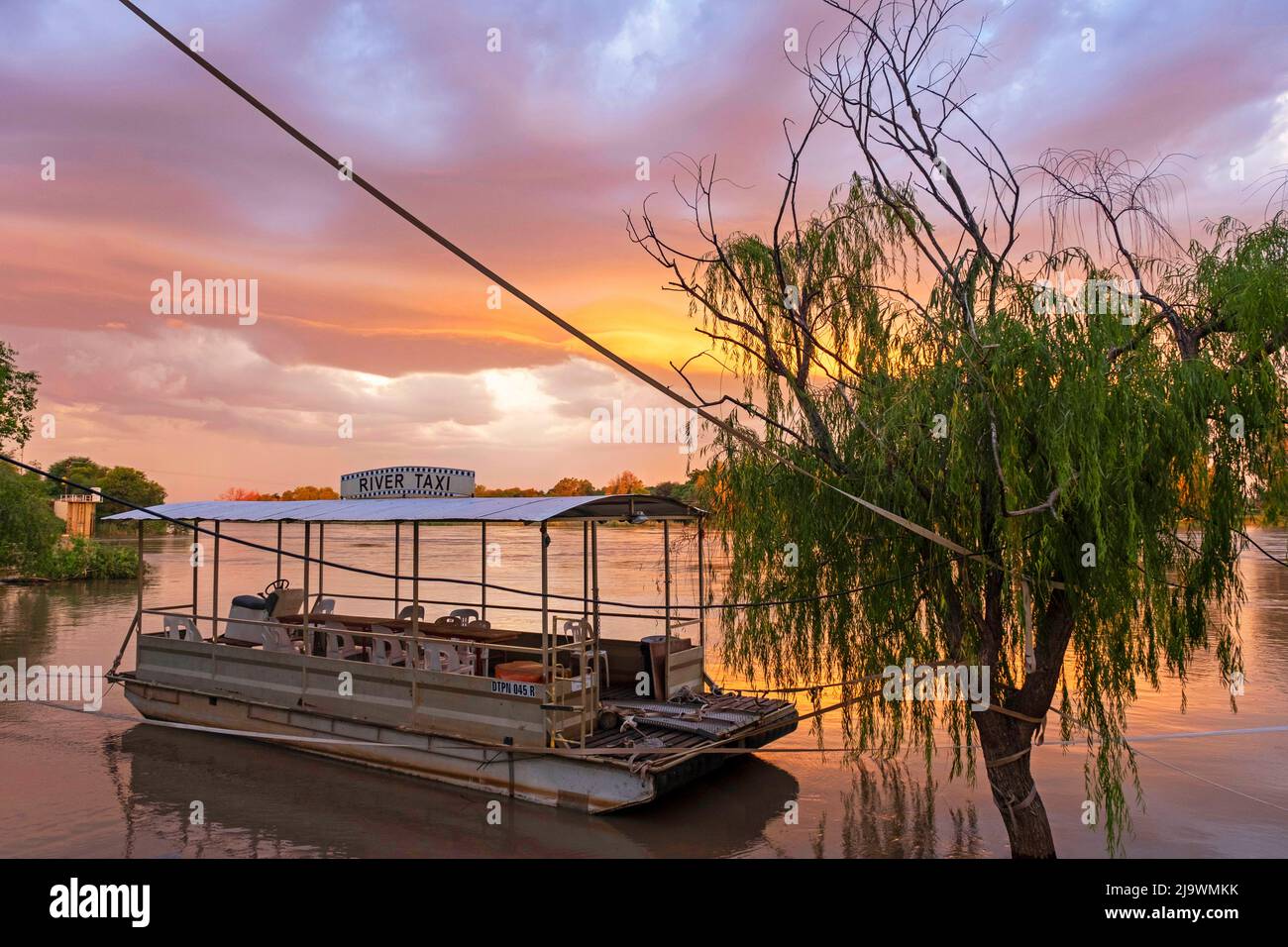 River taxi boat on the Orange river at sunset near Upington, Northern Cape province, South Africa Stock Photo