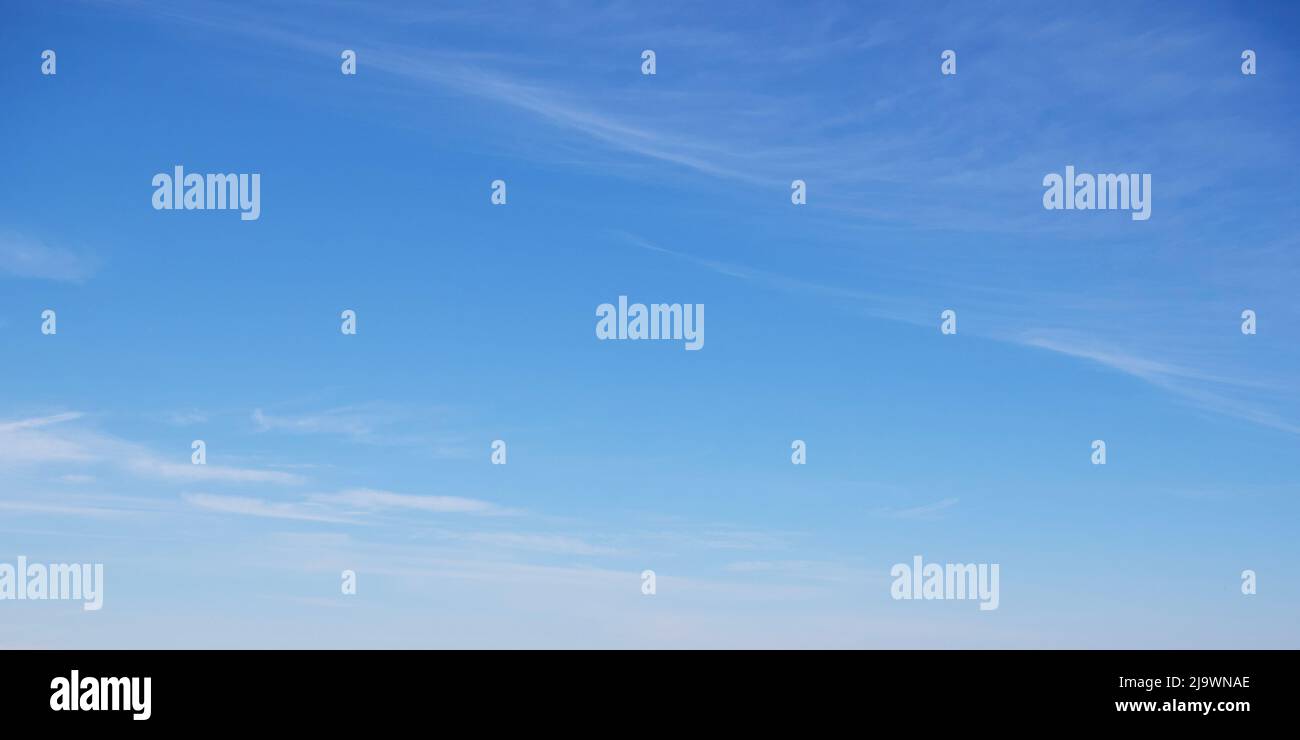 Thin transparent clouds in the blue sky, full frame. Blue sky as a background. Stock Photo