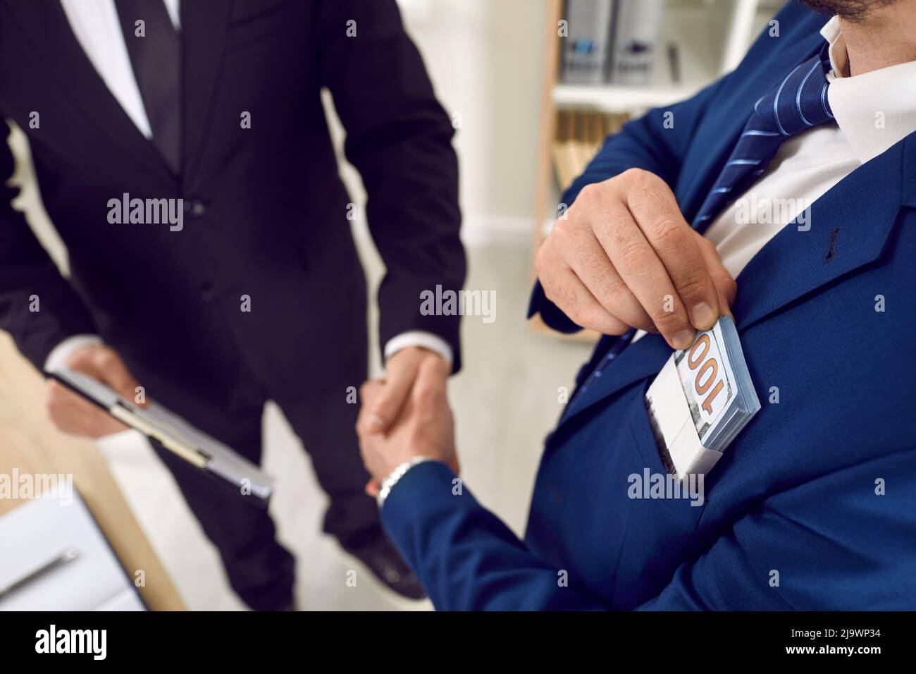 Business people cooperate, make money deal, sign agreement, and exchange handshakes Stock Photo