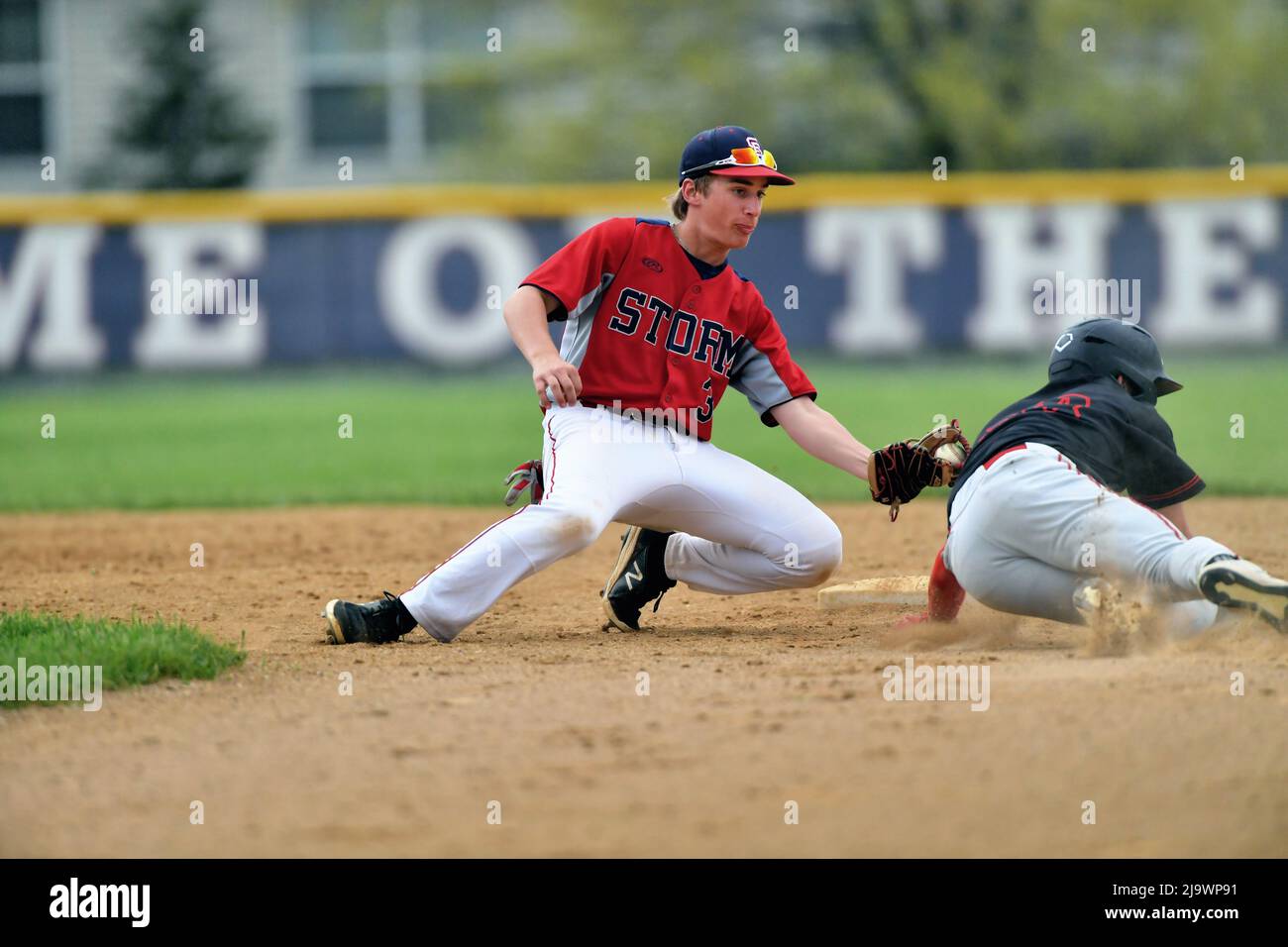 USA. Shortstop applying a tag on a baserunner thwarting a steal attempt. Stock Photo