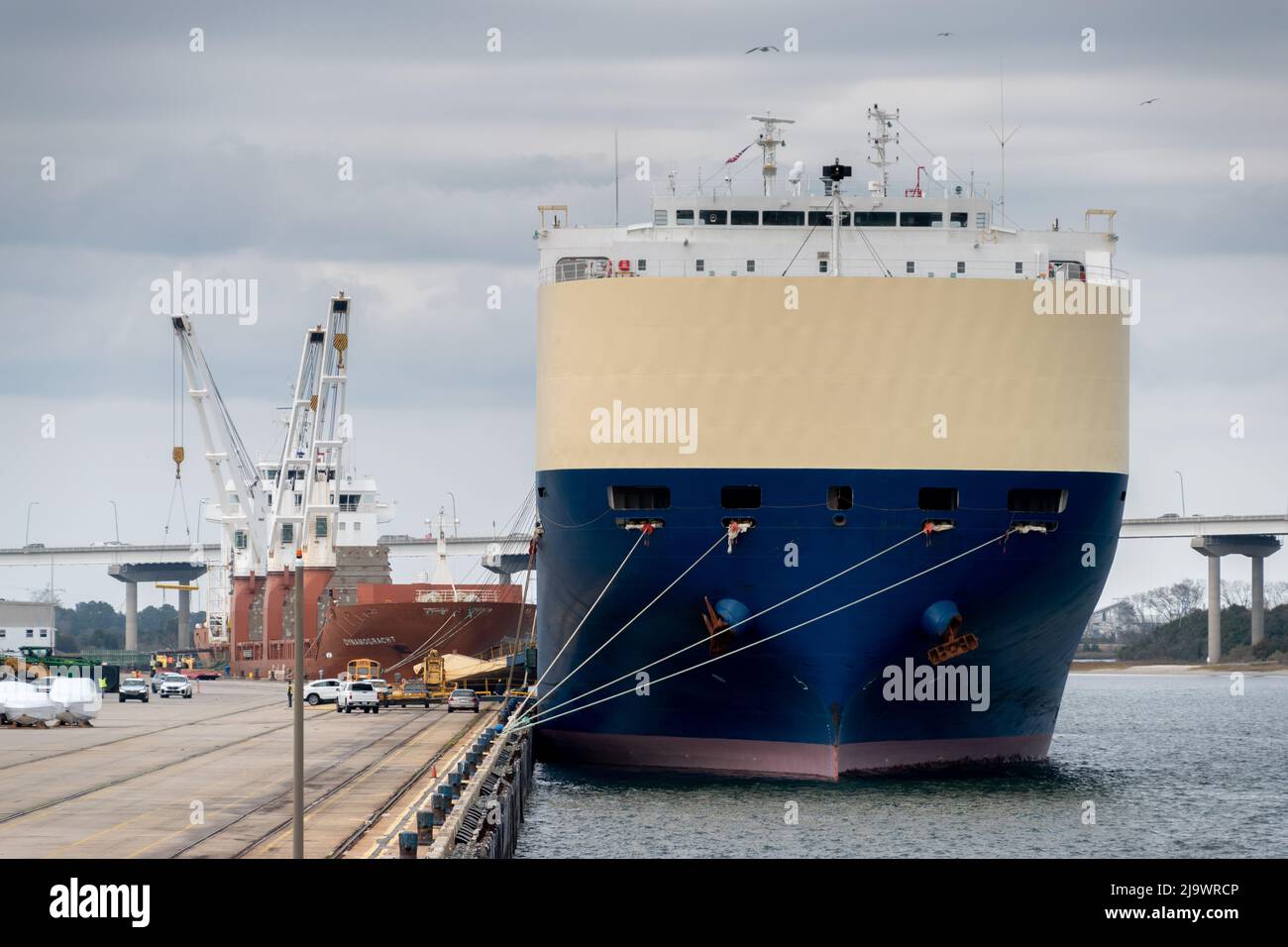 A cargo ship waiting at the port of Charleston Stock Photo Alamy