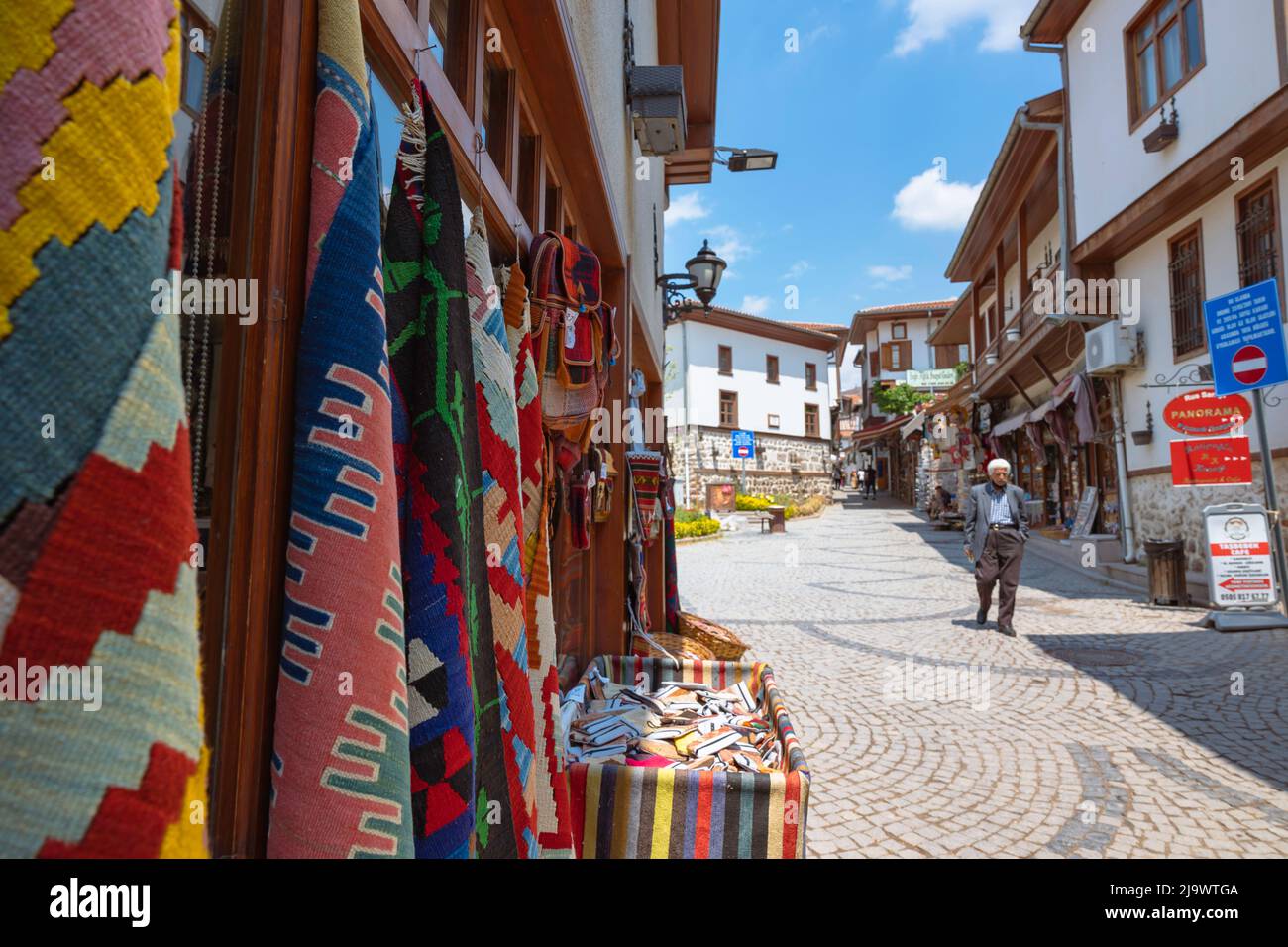 A rug store in Ankara Castle and houses and people on the background. Ankara Turkey - 5.16.2022 Stock Photo