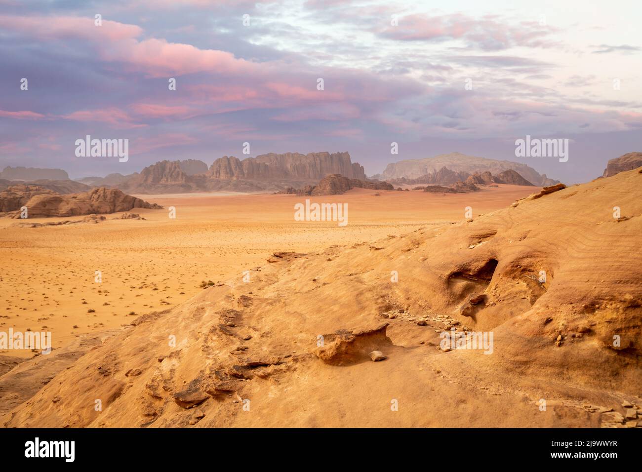 Red sands, mountains, dramatic sky and marthian landscape panorama of Wadi Rum desert, Jordan Stock Photo