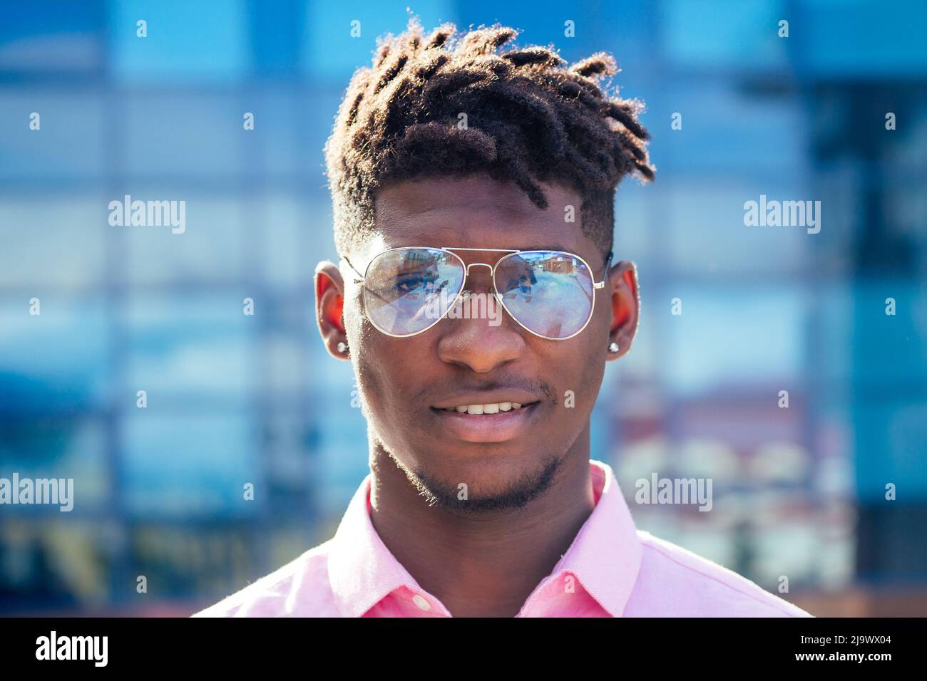 portrait stylish and handsome African student American man with cool dreadlocks and earringin the ear diamond fashion look walking on the street Stock Photo Alamy