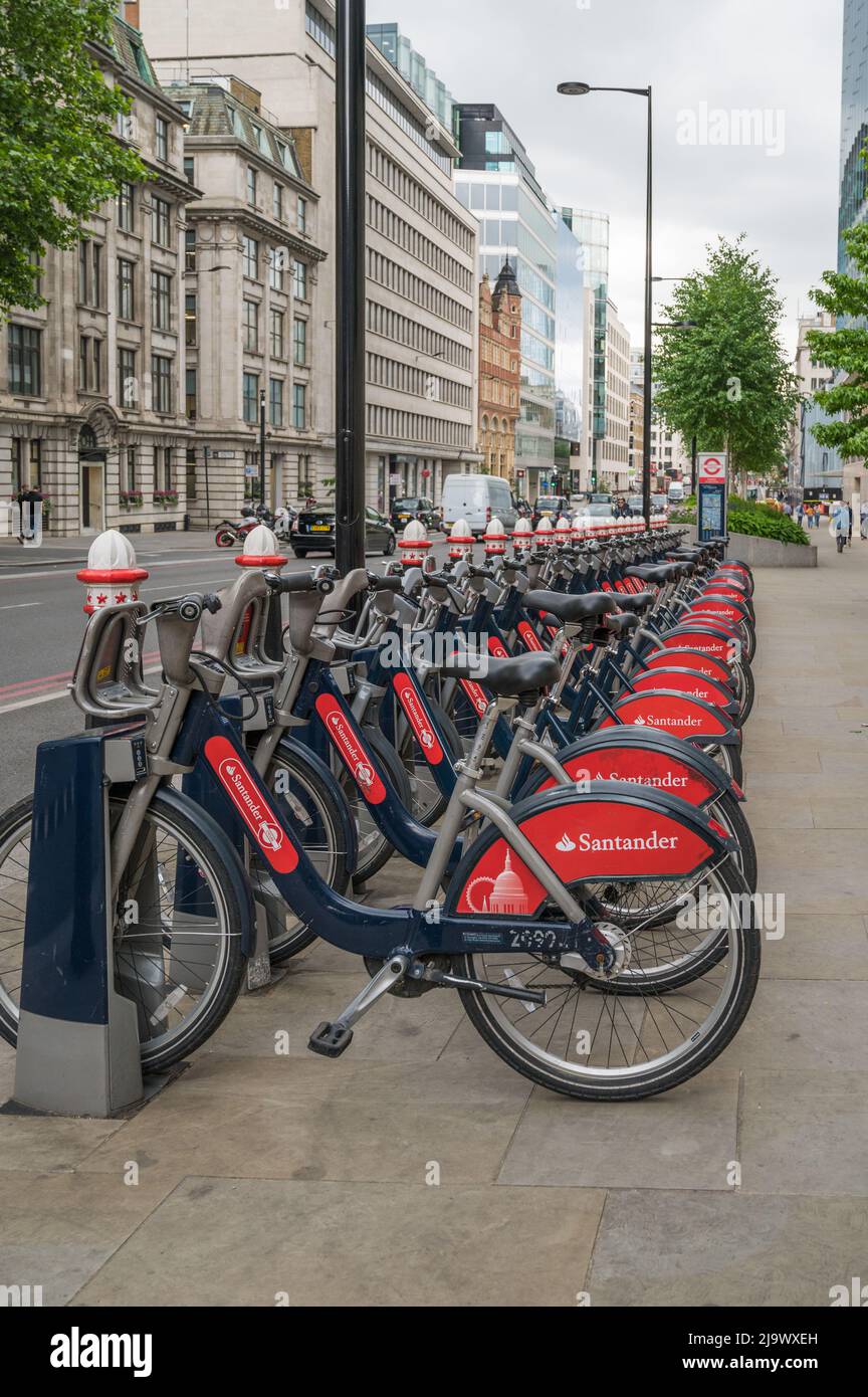 A line of Santander sponsored public hire bicycles parked in a docking station on Farringdon Street, London, England, UK. Stock Photo