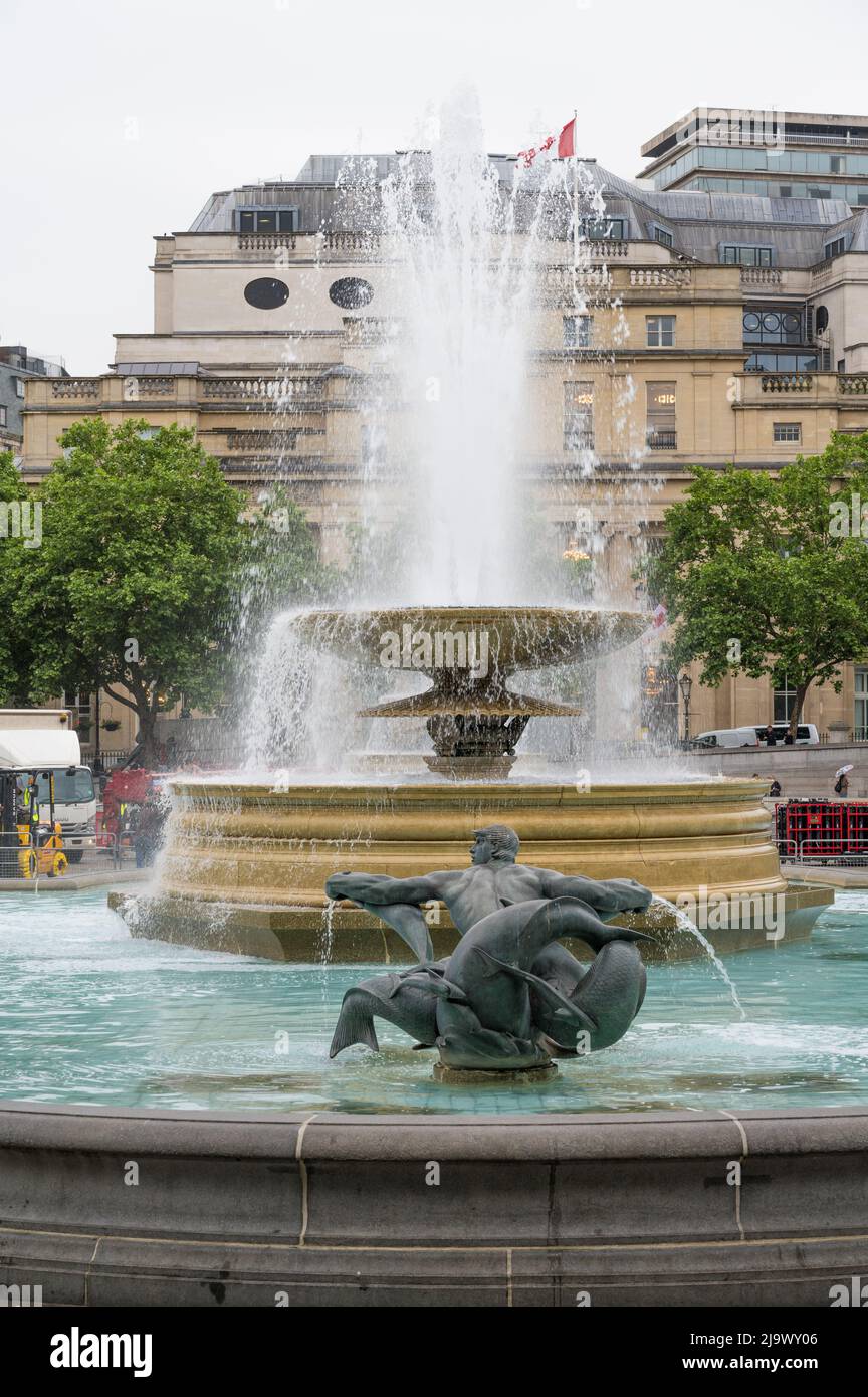 Working fountain in Trafalgar Square with Canada House visible in background. London, England, UK Stock Photo