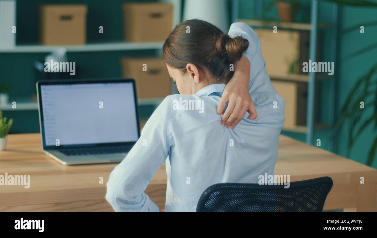 Back View of Woman Tired of Long Sedentary Lifestyle, Rubbing Massaging ...