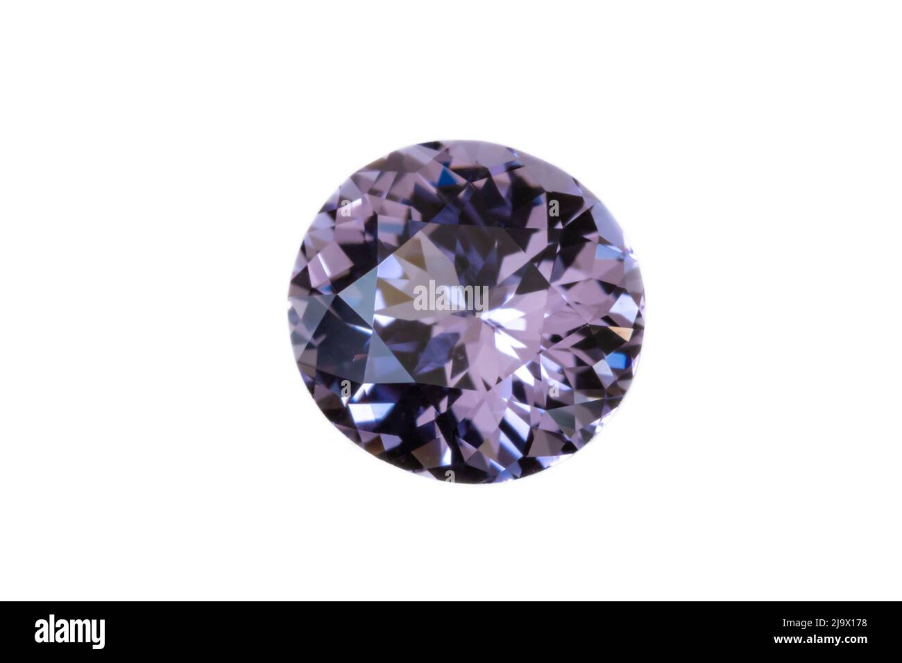 Faceted Lilac-colored Spinel gemstone from Sri Lanka. Silight Oval/near round, 7x7.6mm. Weight 1.64 carats. Photographed with white background. Stock Photo