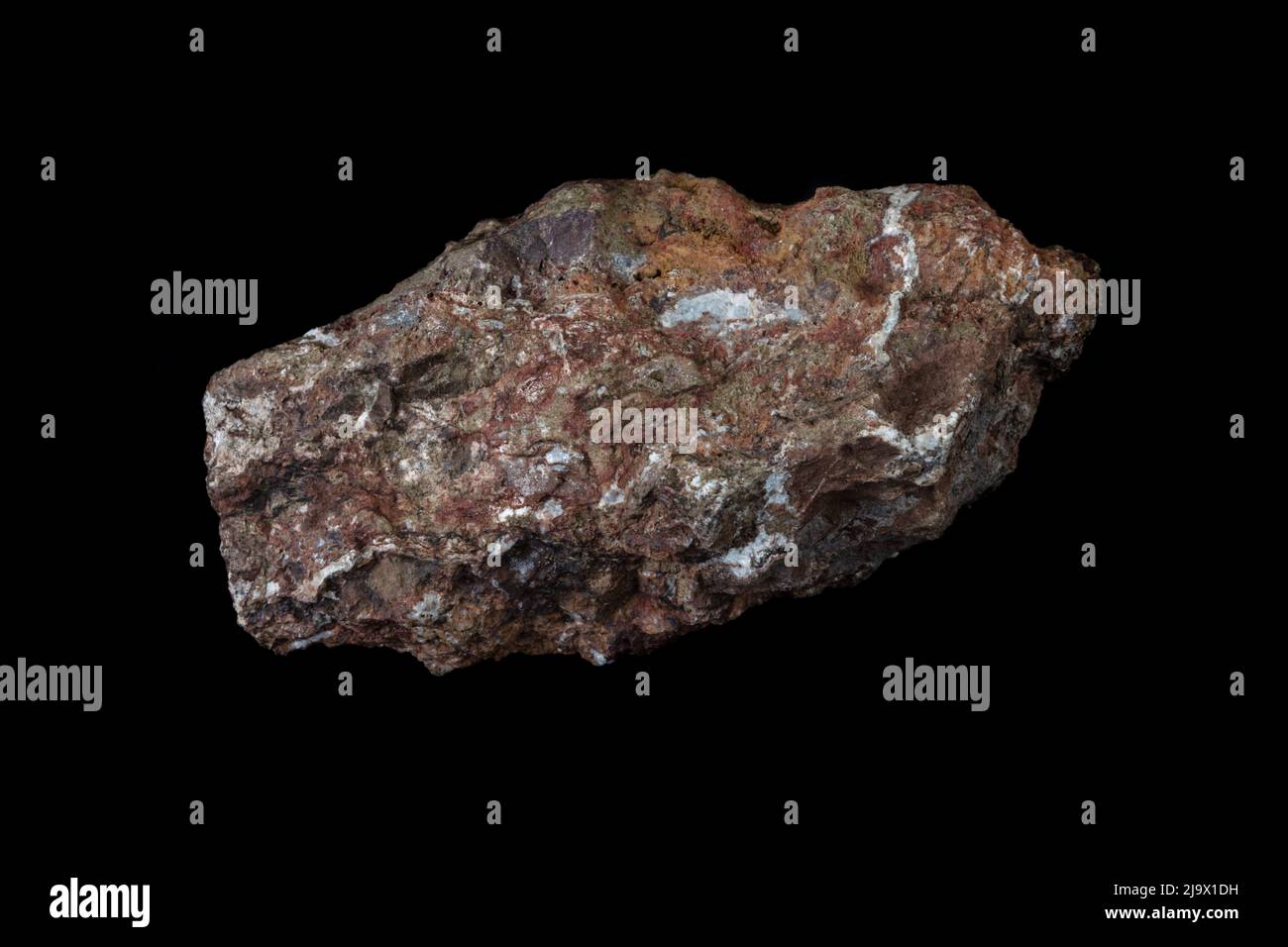 Chlorargyrite (silver ore) specimen, from the Purple Passion mine near Wickenburg, Arizona. Brown and orange with white quartz deposits. Photographed w Stock Photo