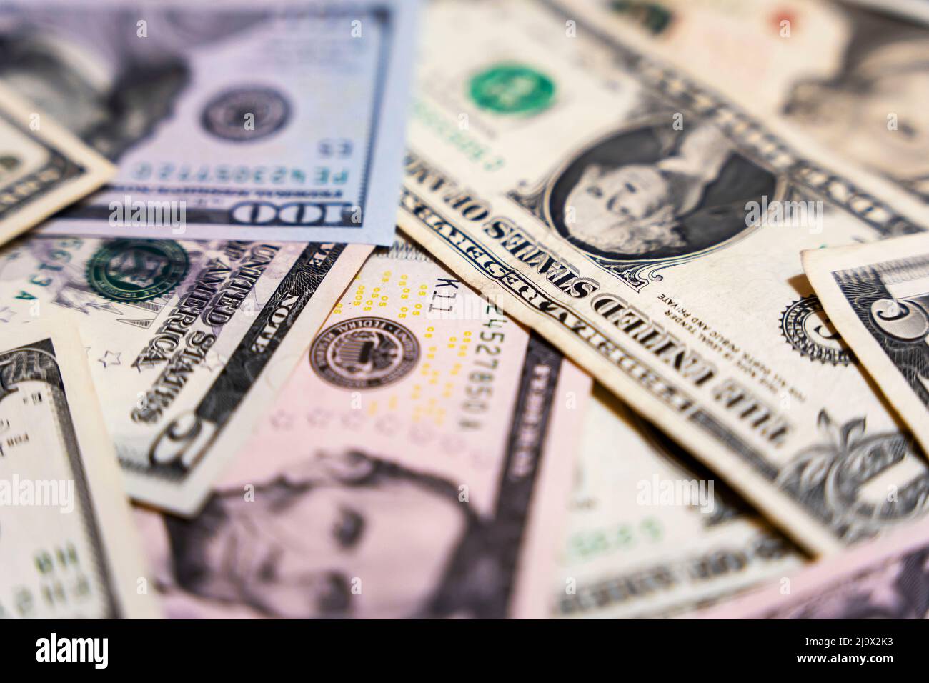 there are dollar bills on the table . background of banknotes Stock Photo