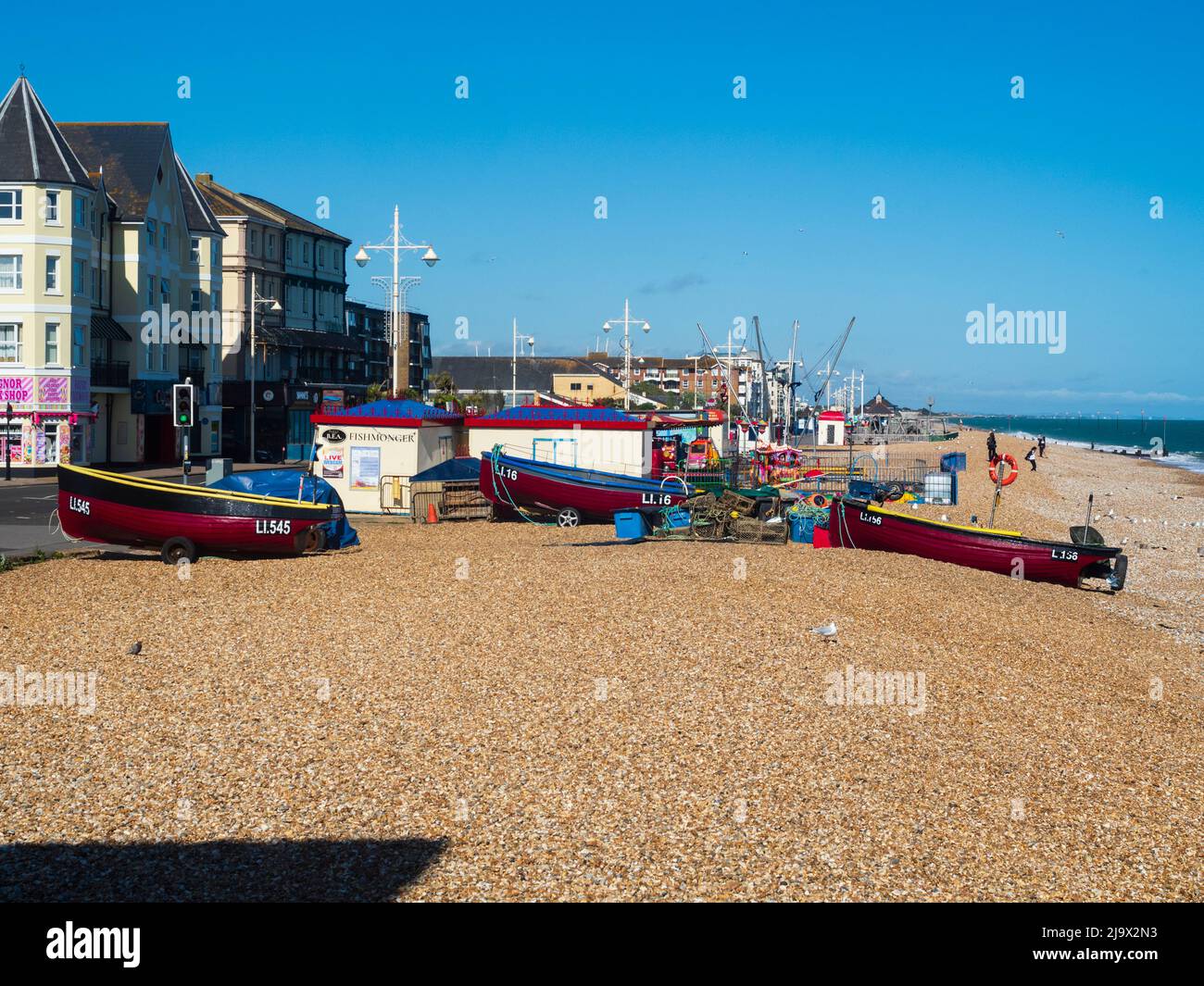 Inshore fishing boats drawn up on the shingle beach at Bognor Regis, West Sussex, UK Stock Photo