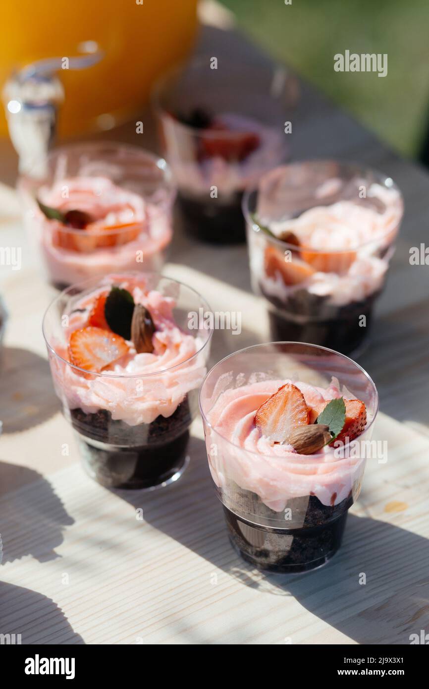 Pink Frosted Cupcakes with a Strawberry on Top. High quality photo Stock Photo