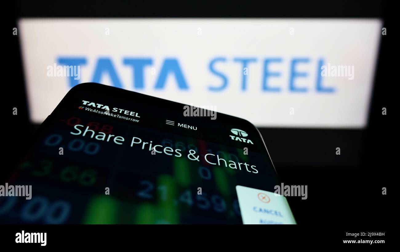 Smartphone with website of Indian steelmaking company Tata Steel Limited on screen in front of business logo. Focus on top-left of phone display. Stock Photo