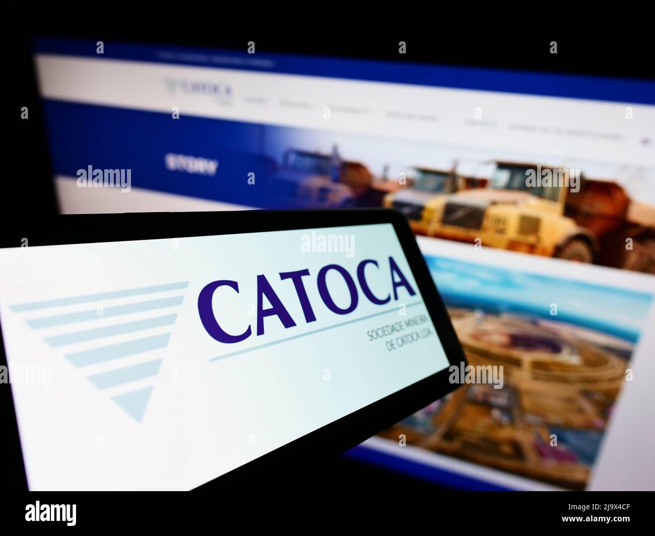 Smartphone with logo of mining company Sociedade Mineira de Catoca Lda. on screen in front of business website. Focus on center of phone display. Stock Photo