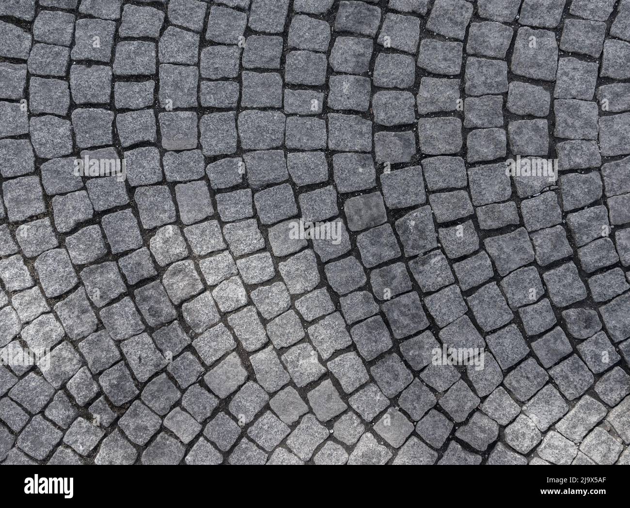 Granite cobblestoned pavement background texture Stock Photo - Alamy