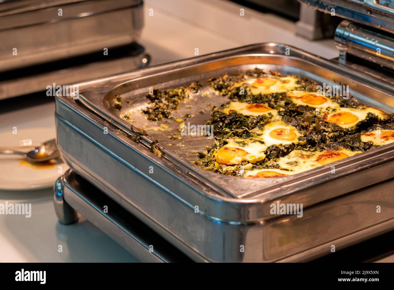 Allinclusive buffet food in heating trays in hotel restaurant with