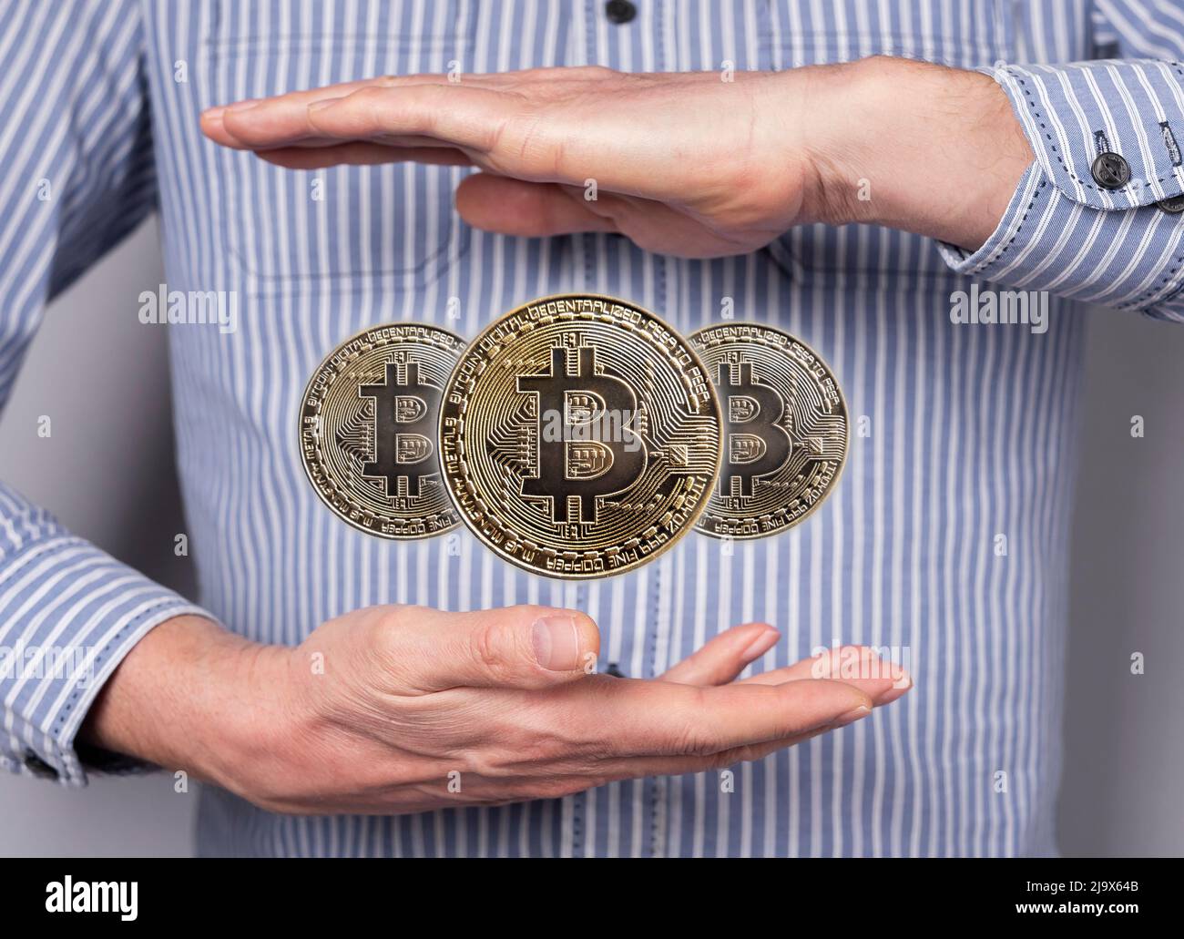Bitcoin coins levitating between man hands. Cryptocurrency, digital money.  Financial concept in abstract style. High quality photo Stock Photo - Alamy