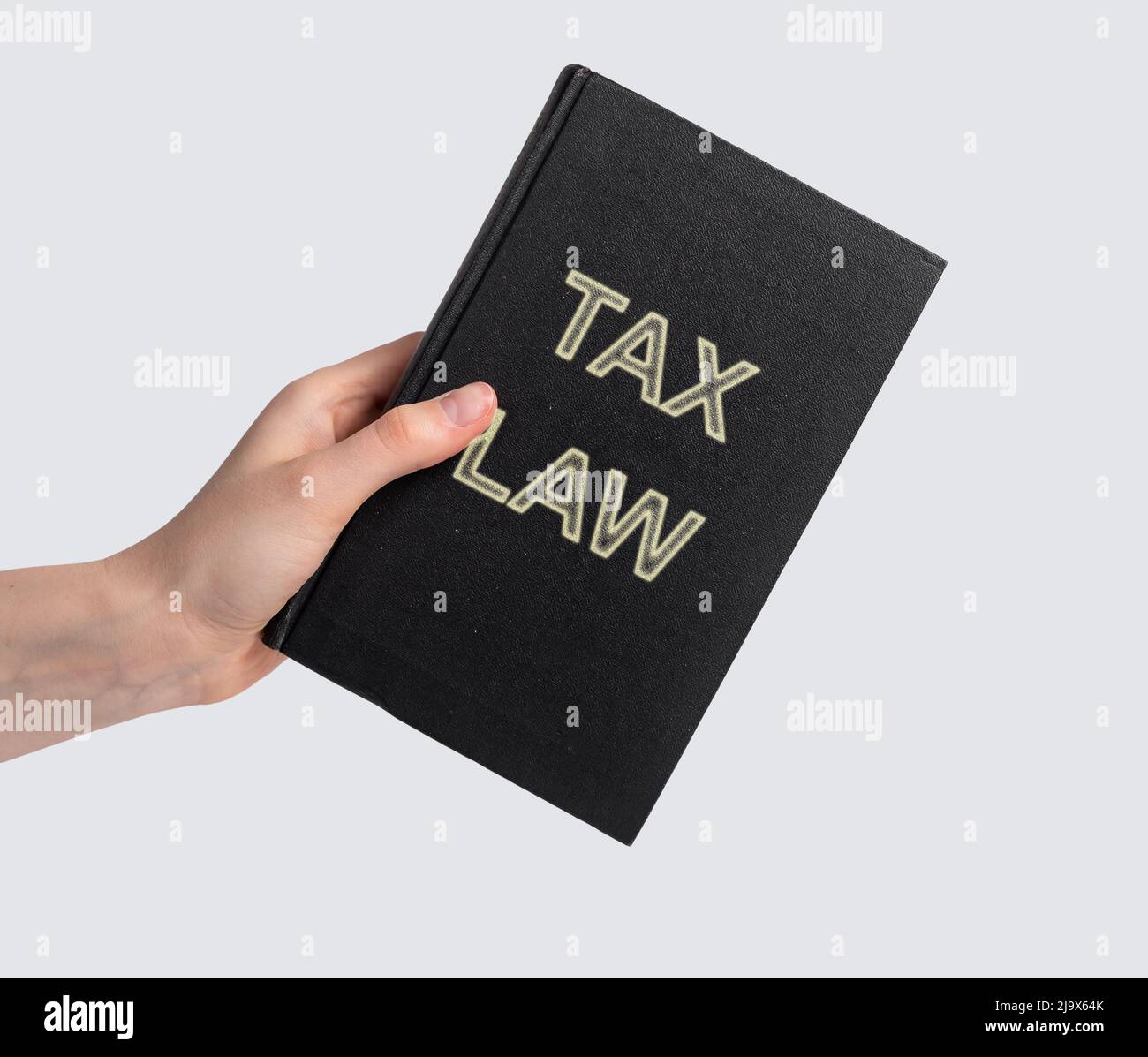 Woman hand with tax law book. Revenue legislation, study of rules to assess and collect levies concept. Code, legal dictionary, guide. Education for becoming lawyer. Literature. photo Stock Photo