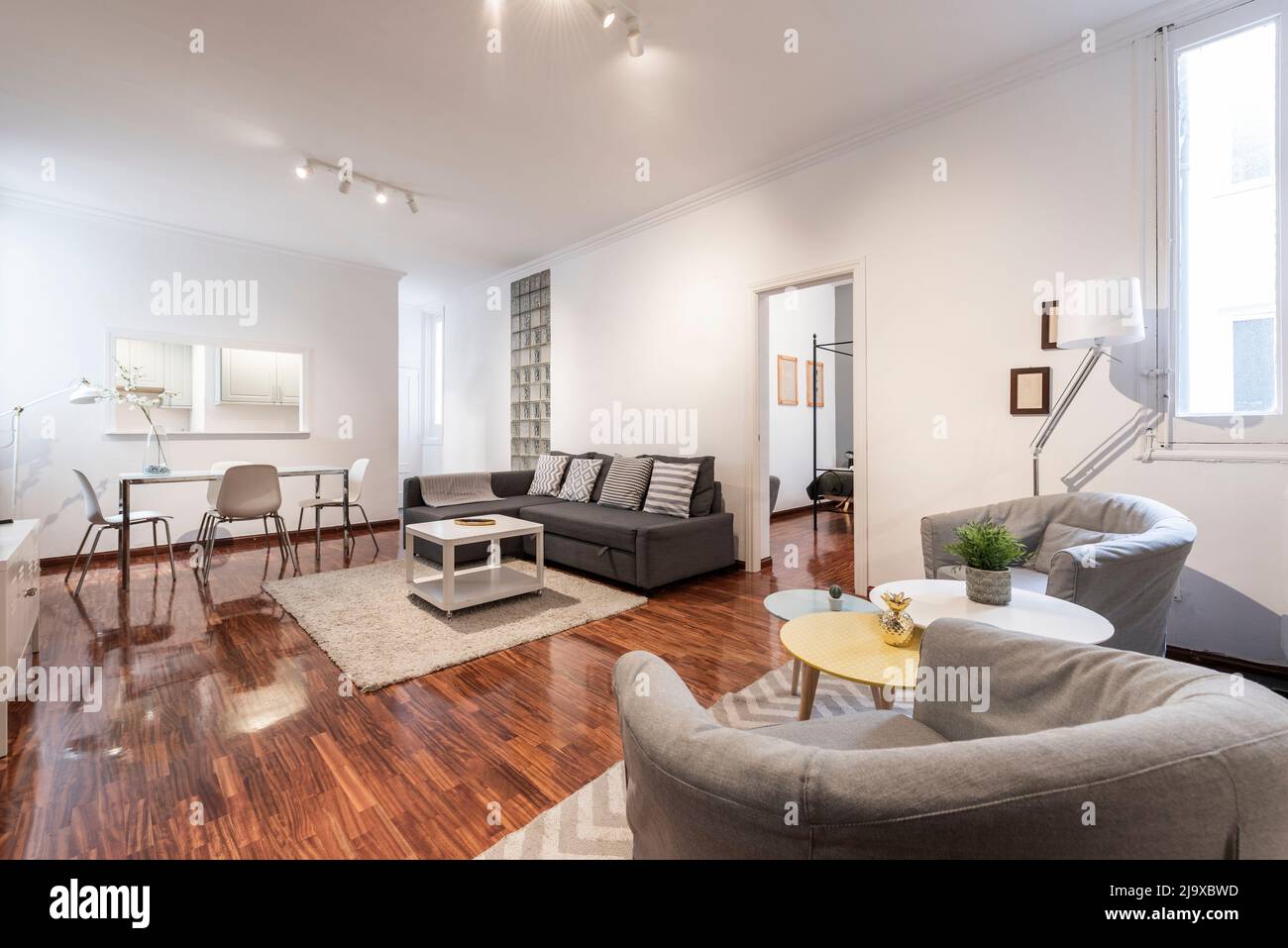 spacious living room with wingback sofas, auxiliary coffee tables, sofa