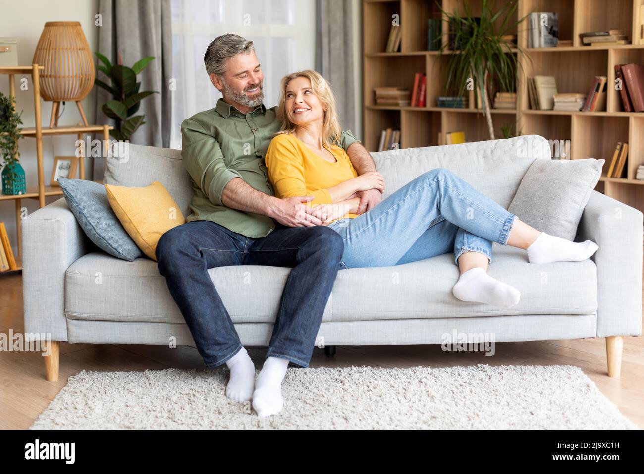 Romantic happy middle aged couple relaxing on couch at home Stock Photo ...