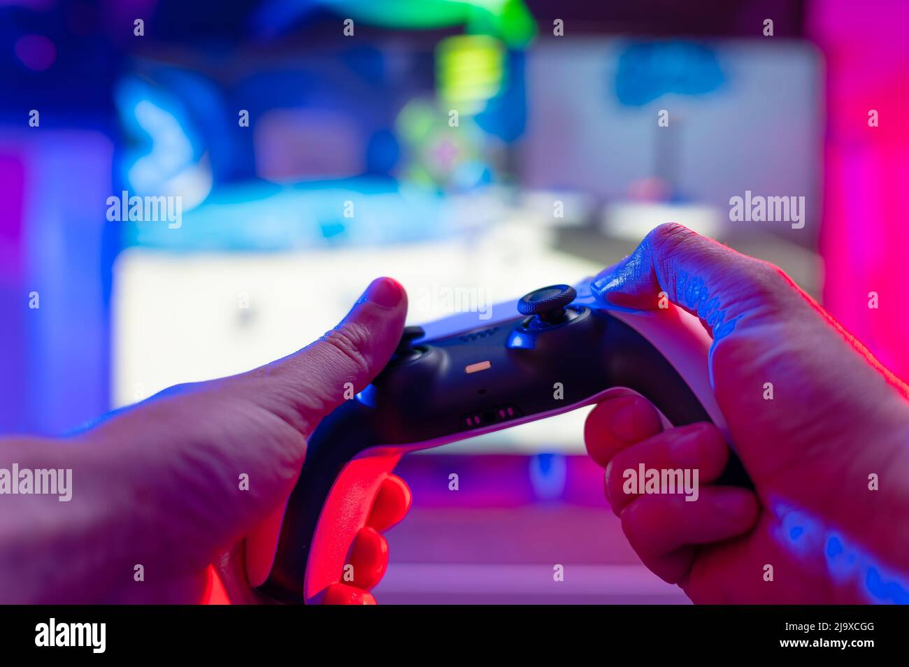 A gamer girl with a joystick in her hands plays video games on a large  monitor of a personal computer. Modern technologies, gadgets, fun pastime,  hobb Stock Photo - Alamy