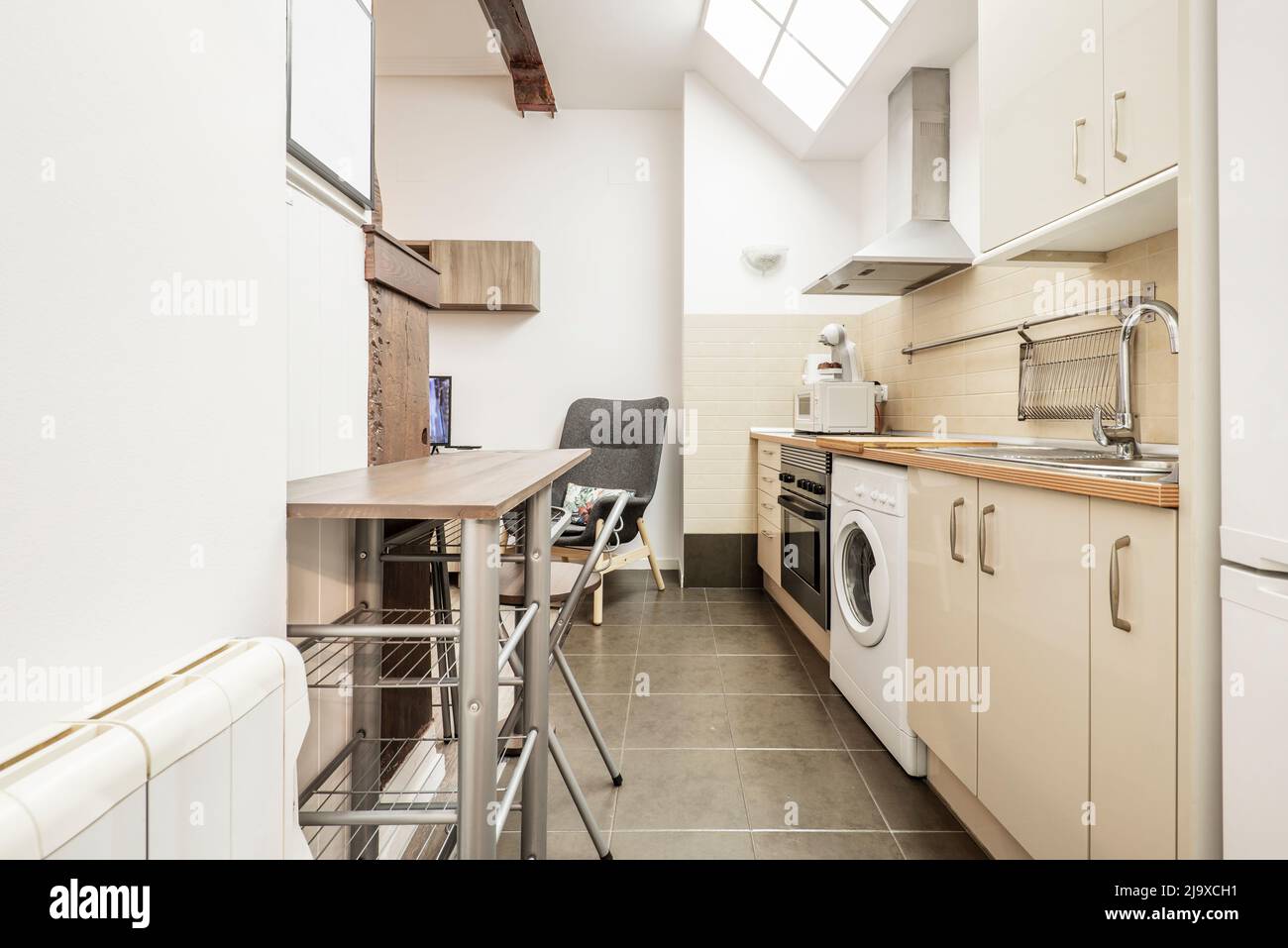 Apartment with open kitchen, creamcolored furniture, integrated