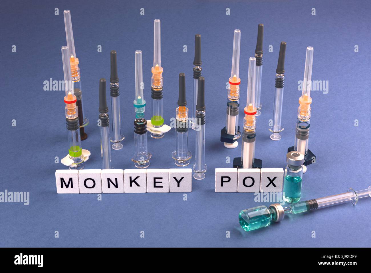 MONKEY POX. Words written on square wooden tiles with vaccine and ...