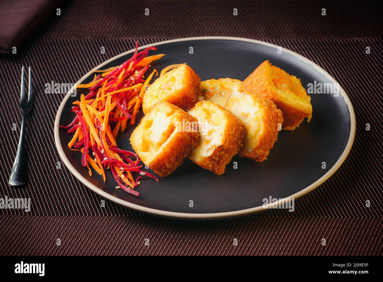 Plate of Japanese sushi rolls with tuna, crab, salmon, eel and gratin rolls, on a fine table Stock Photo